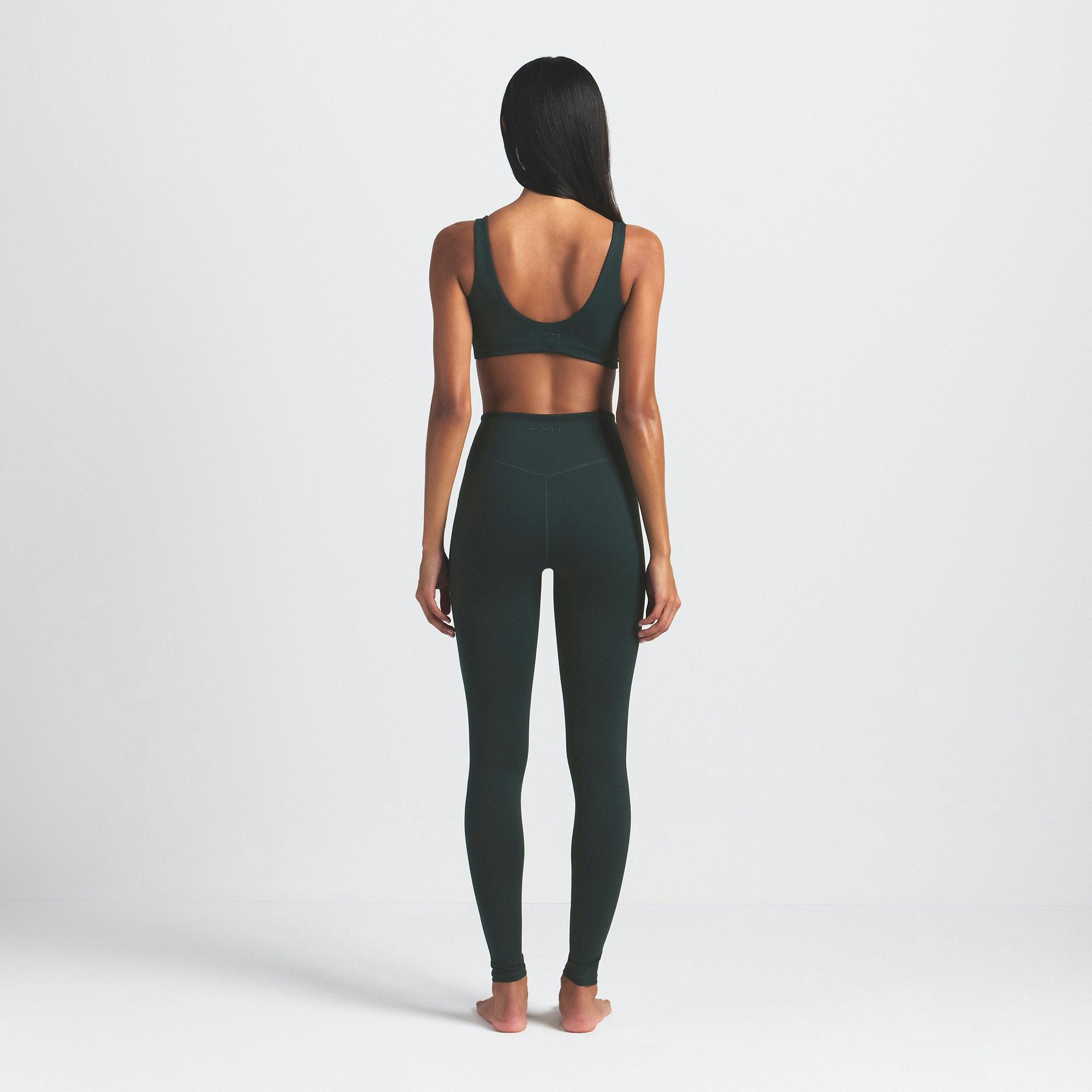 NikeSKIMS MATTE 29" LEGGING | DARK TEAL ON A MODEL SIDE VIEW @ | FOCUS: 0.0, 1.0, 0.9