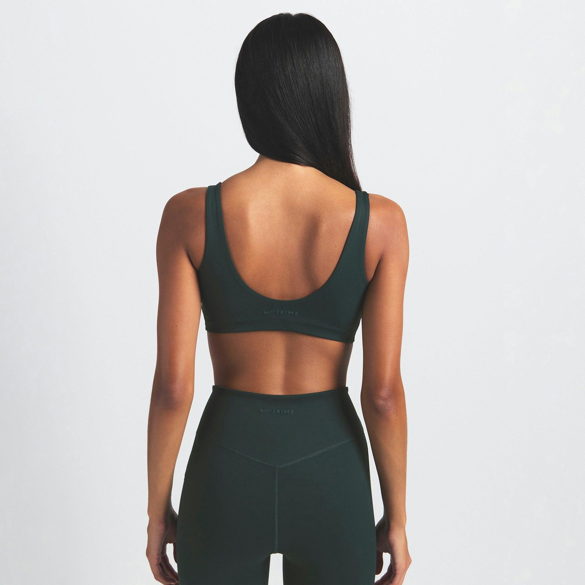 NikeSKIMS MATTE 29" LEGGING | DARK TEAL ON A MODEL SIDE VIEW @ | FOCUS: 0.0, 1.0, 0.9