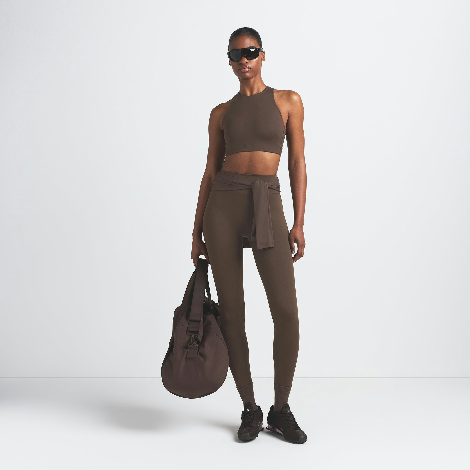 NikeSKIMS MATTE 29" LEGGING | DARK SEPIA ON A MODEL FRONT VIEW @ | FOCUS: 0.9, 0.1, 0.7