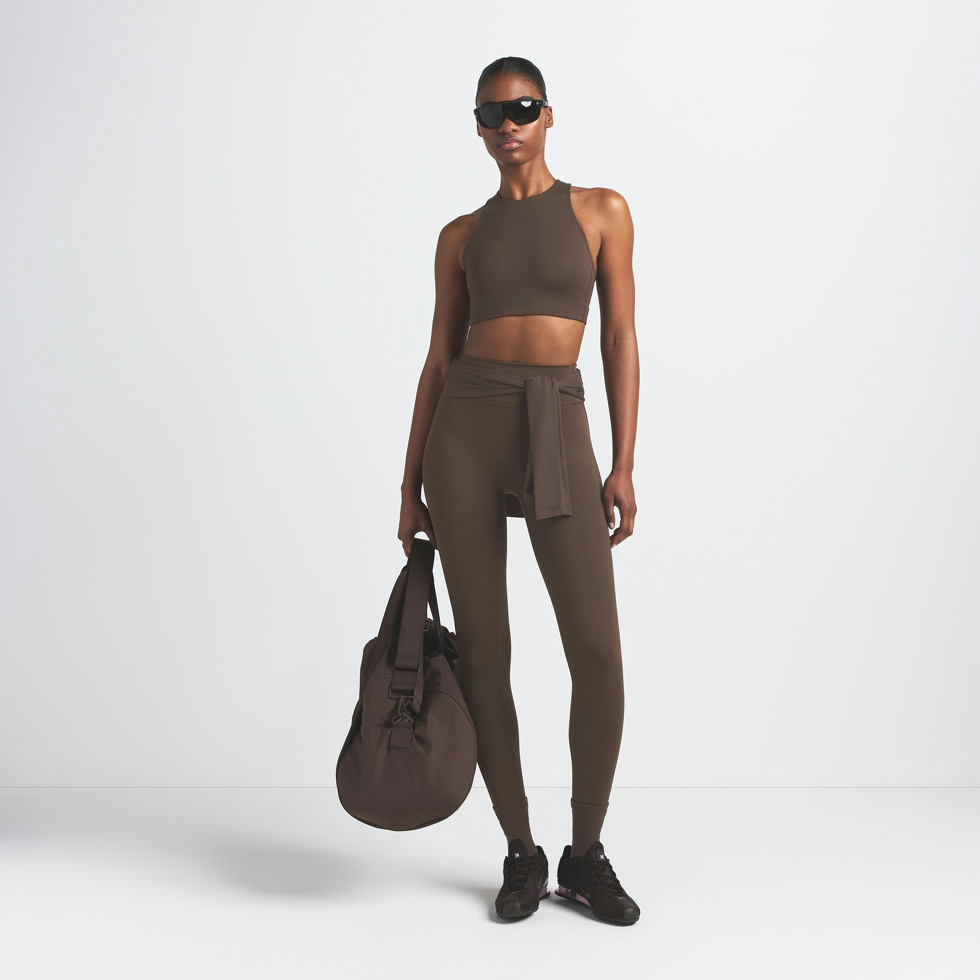 NikeSKIMS MATTE 29" LEGGING | DARK SEPIA ON A MODEL FRONT VIEW @ | FOCUS: 0.9, 0.1, 0.7