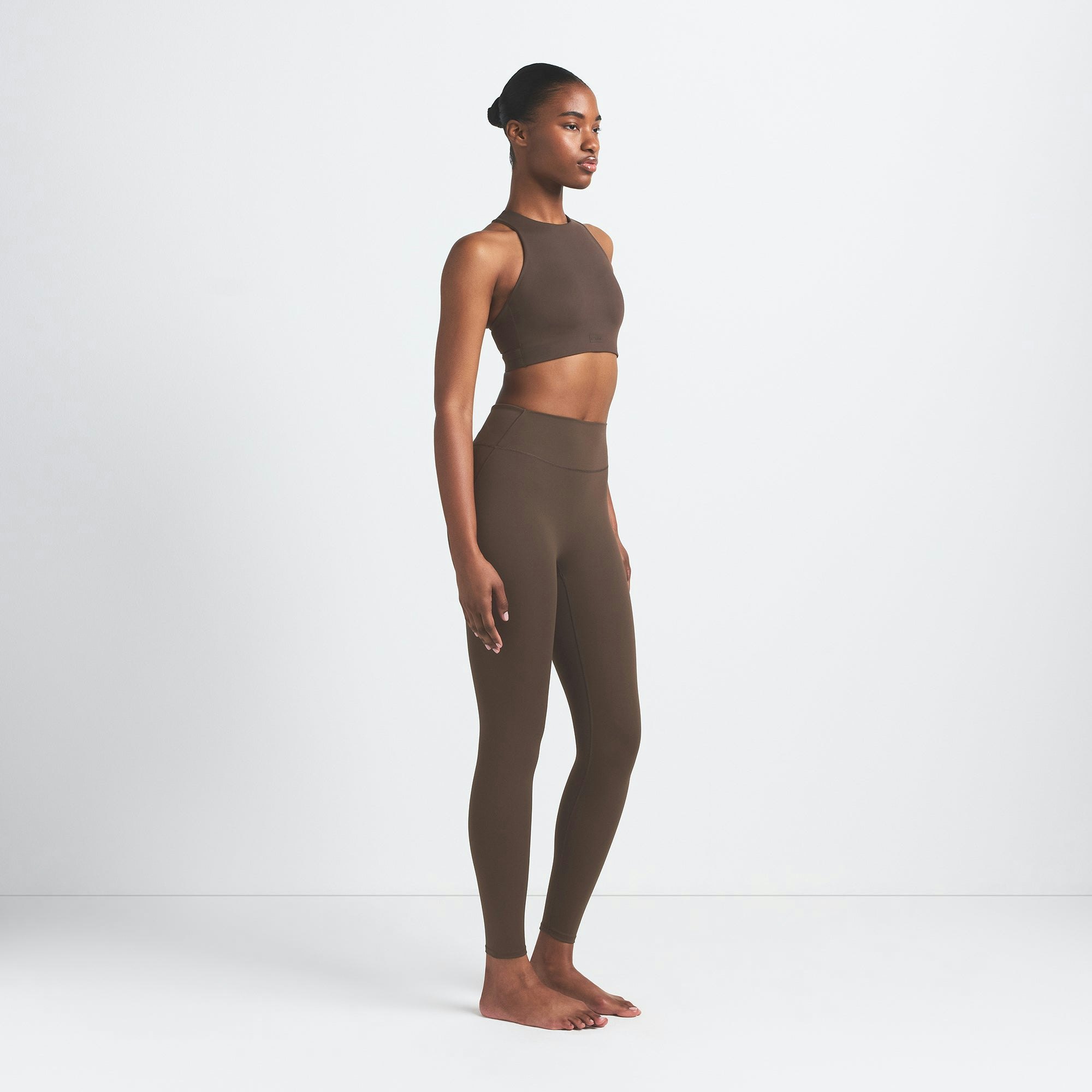 NikeSKIMS MATTE 29" LEGGING | DARK SEPIA ON A MODEL SIDE VIEW
