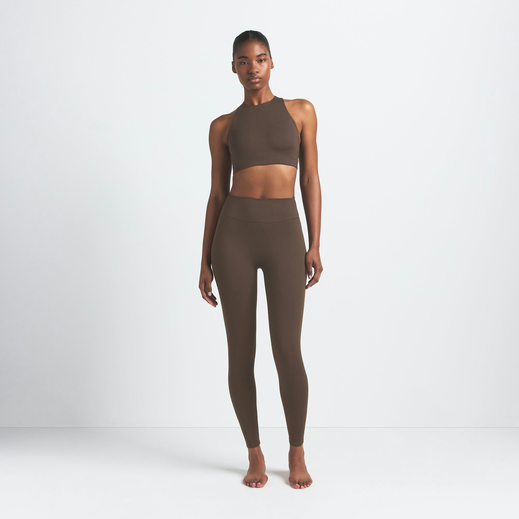 NikeSKIMS MATTE 29" LEGGING | DARK SEPIA ON A MODEL FRONT VIEW