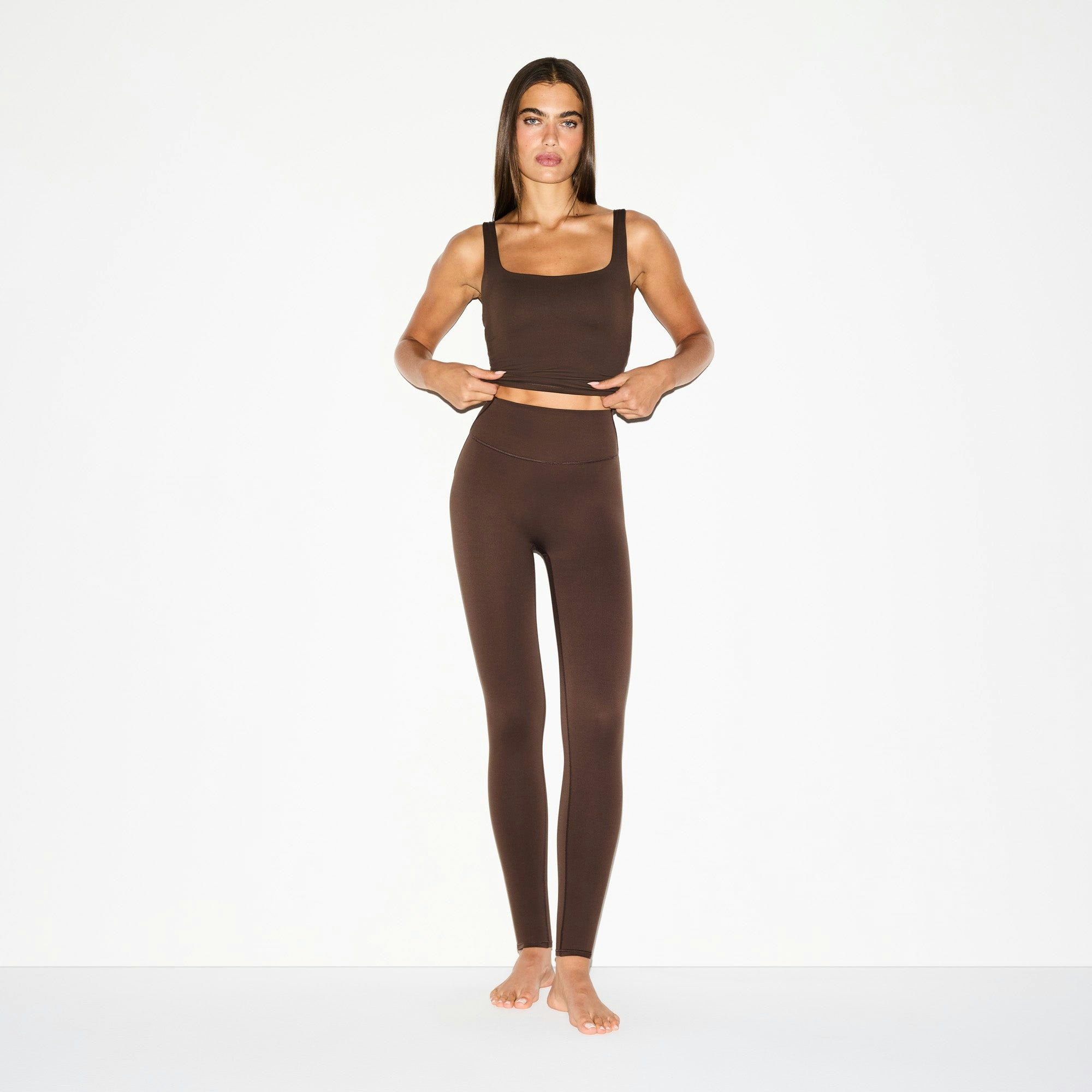 NikeSKIMS MATTE 29" LEGGING | DARK SEPIA ON A MODEL FRONT VIEW @ | FOCUS: 0.0, 1.0, 0.9