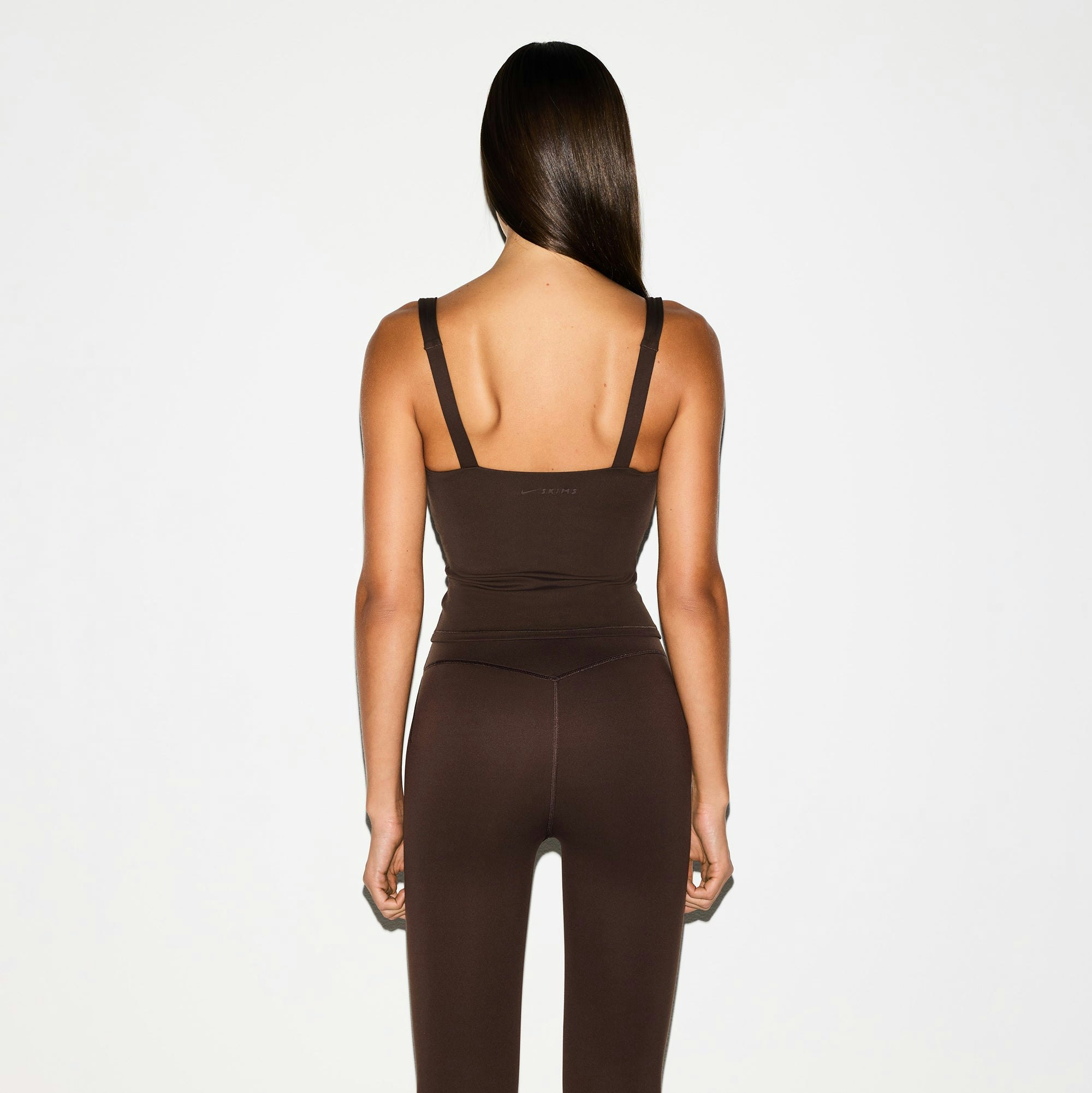 NikeSKIMS MATTE 29" LEGGING | DARK SEPIA ON A MODEL BACK VIEW @ | FOCUS: 0.0, 1.0, 0.9