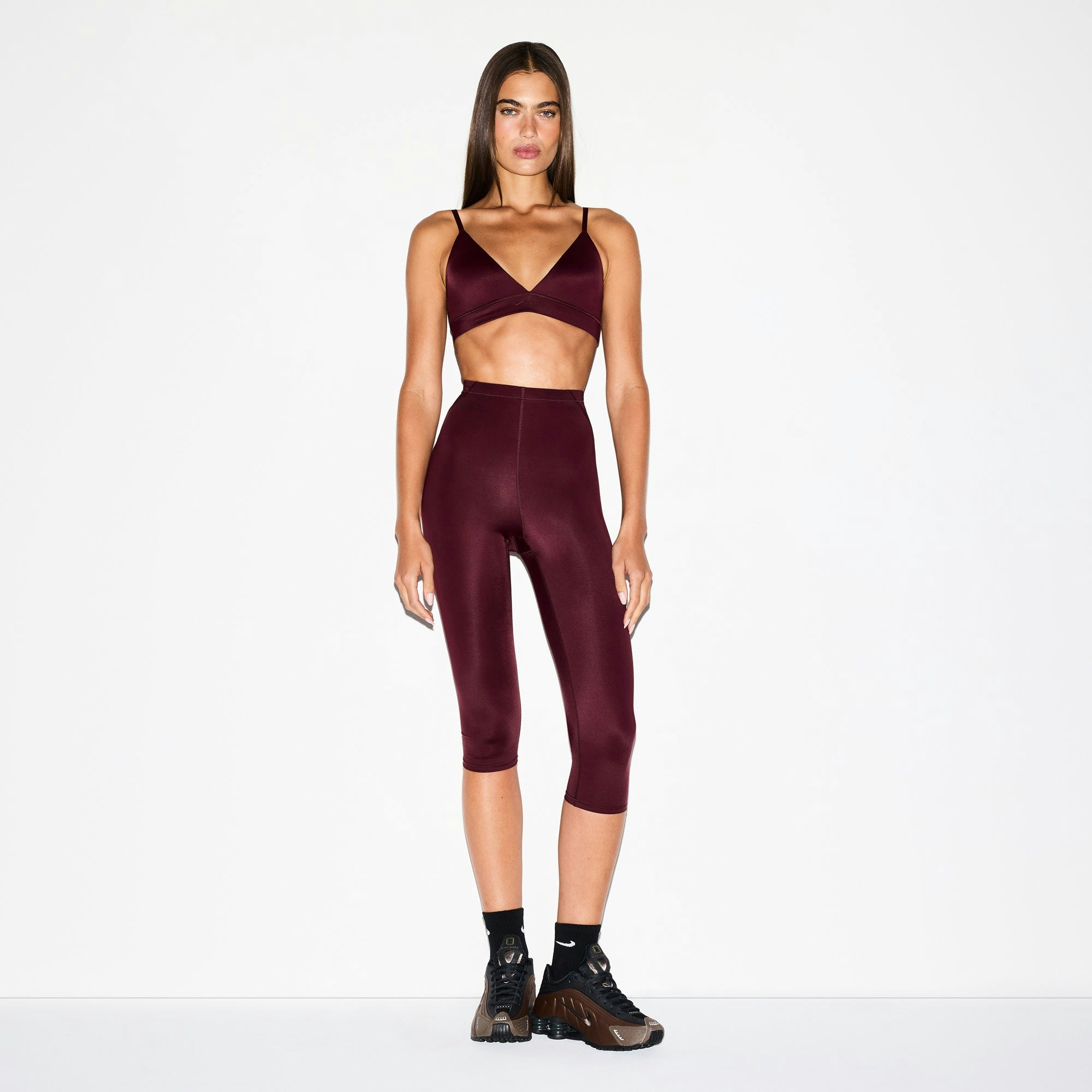 NikeSKIMS SHINE DRAWCORD CROP 17" LEGGING | CURRANT ON A MODEL FRONT VIEW @ | FOCUS: 0.0, 1.0, 0.9