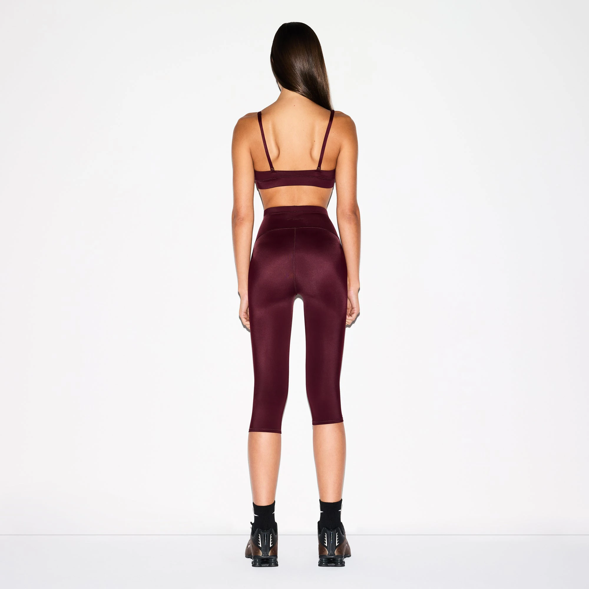 NikeSKIMS SHINE DRAWCORD CROP 17" LEGGING | CURRANT ON A MODEL FRONT VIEW @ | FOCUS: 0.0, 1.0, 0.9