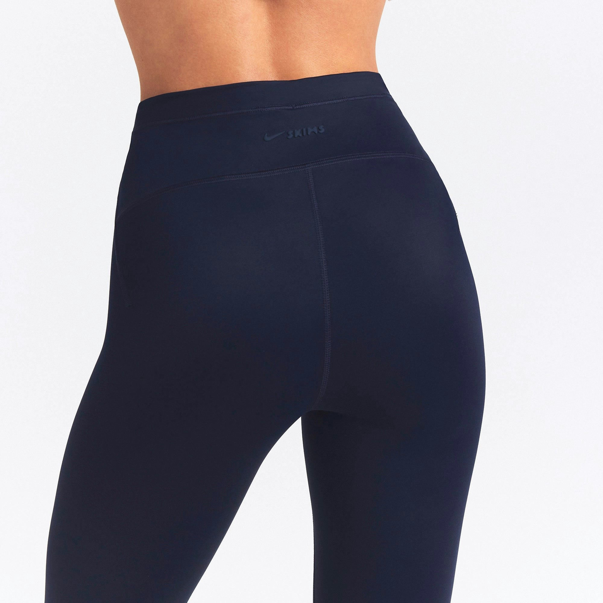 NikeSKIMS SHINE DRAWCORD CROP 17" LEGGING | NAVY ON A MODEL SIDE VIEW @ | FOCUS: 0.0, 1.0, 0.9