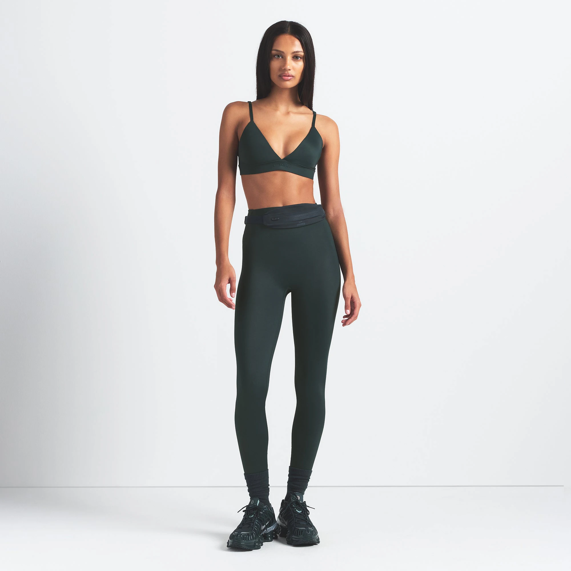 NikeSKIMS SHINE BONDED WAIST 26" LEGGING | DARK TEAL ON A MODEL FRONT VIEW @ | FOCUS: 0.0, 1.0, 0.9