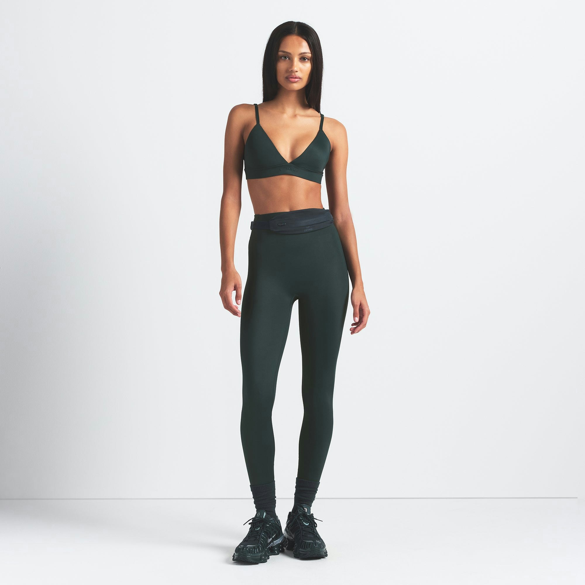 NikeSKIMS SHINE BONDED WAIST 26" LEGGING | DARK TEAL ON A MODEL FRONT VIEW @ | FOCUS: 0.0, 1.0, 0.9