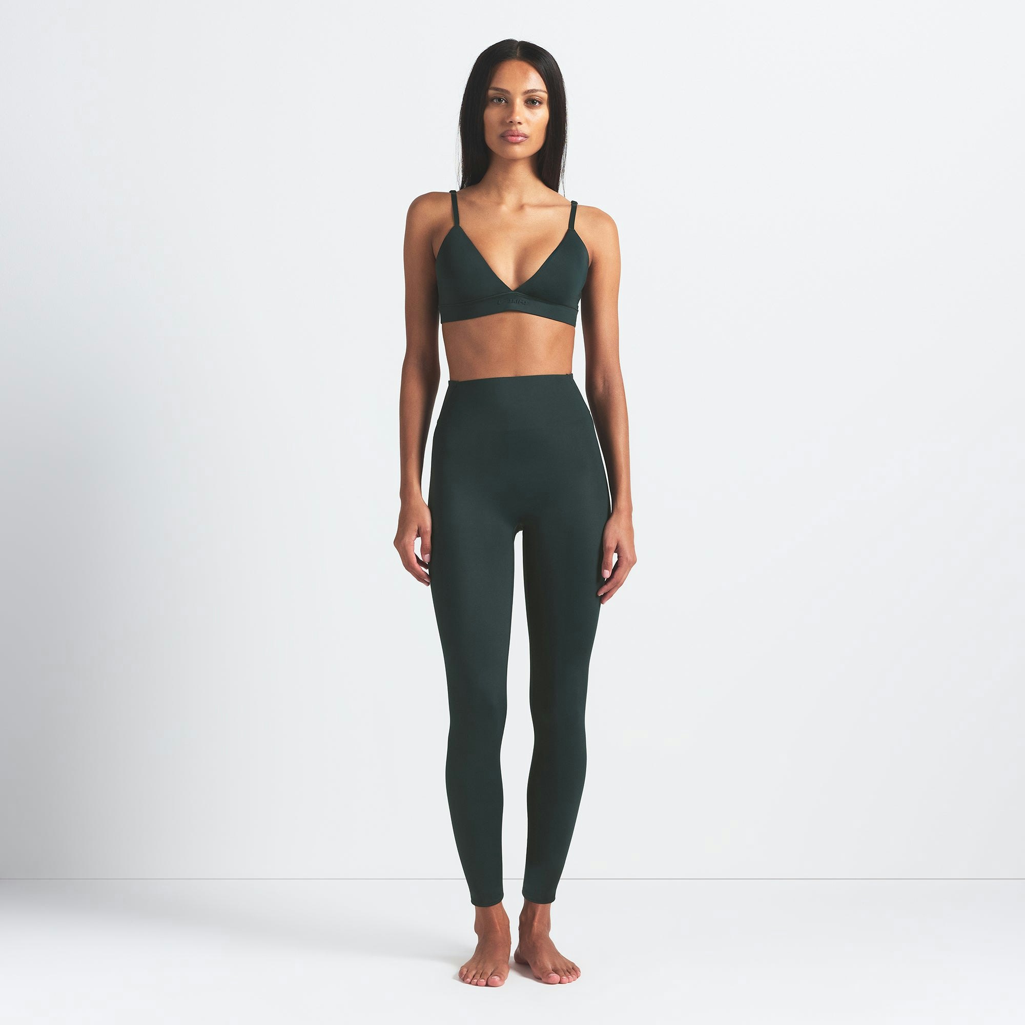 NikeSKIMS SHINE BONDED WAIST 26" LEGGING | DARK TEAL ON A MODEL FRONT VIEW @ | FOCUS: 0.0, 1.0, 0.9