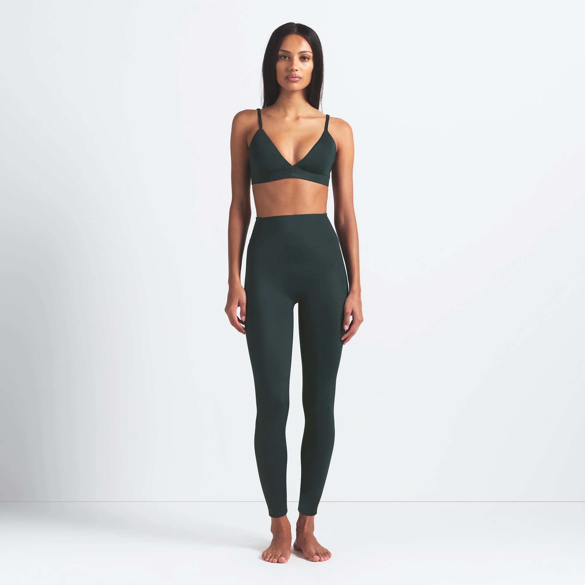 NikeSKIMS SHINE BONDED WAIST 26" LEGGING | DARK TEAL ON A MODEL FRONT VIEW @ | FOCUS: 0.0, 1.0, 0.9