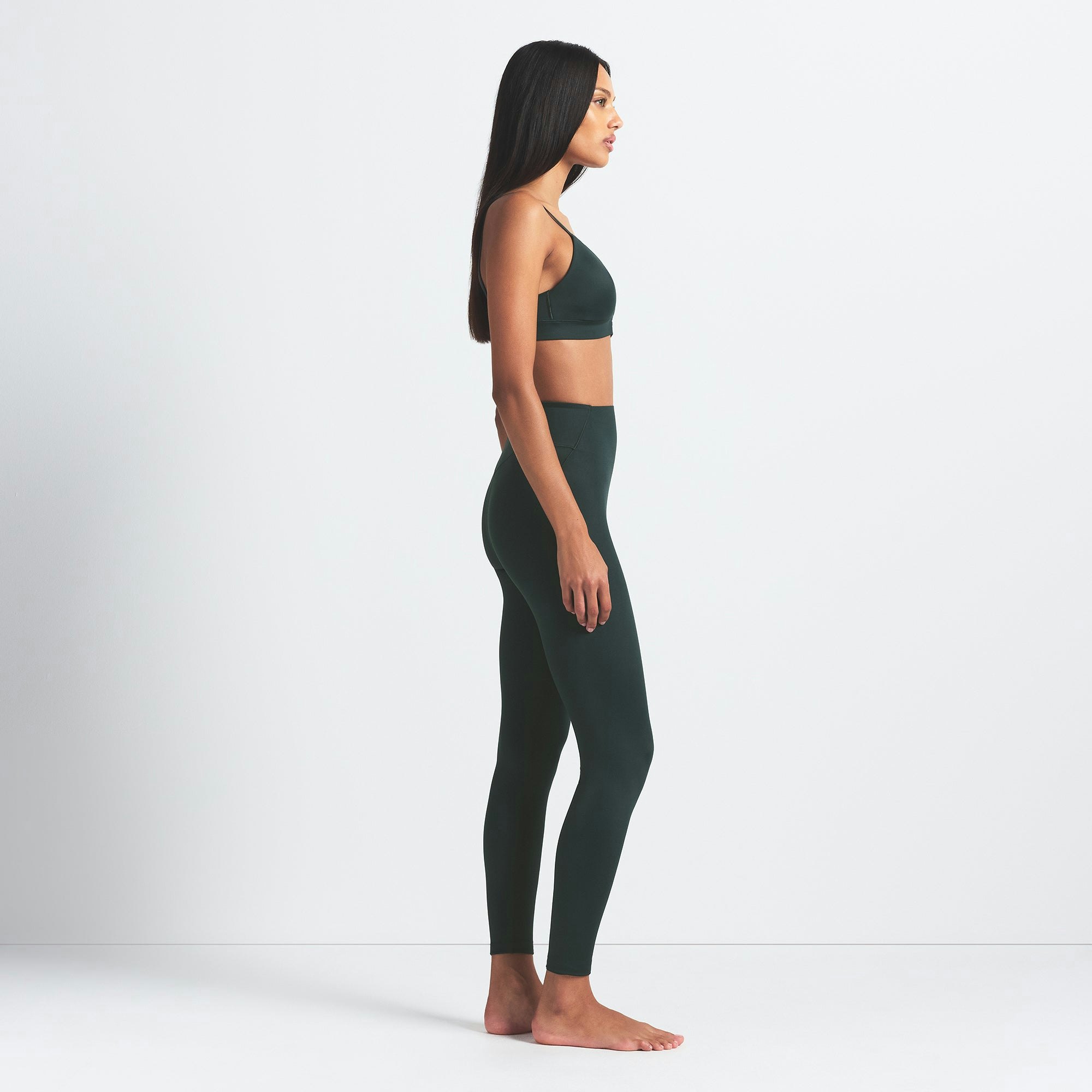 NikeSKIMS SHINE BONDED WAIST 26" LEGGING | DARK TEAL ON A MODEL FRONT VIEW @ | FOCUS: 0.0, 1.0, 0.9
