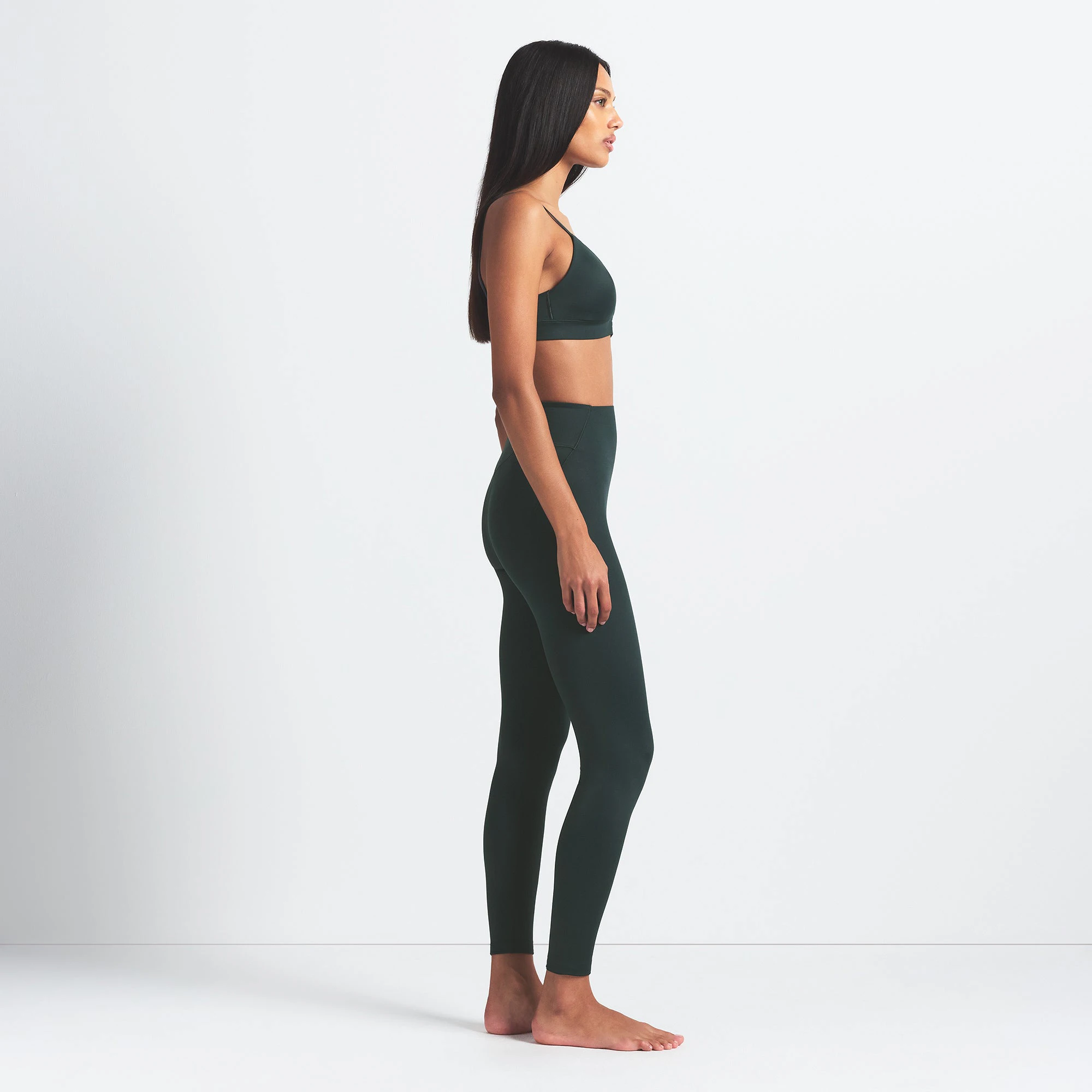 NikeSKIMS SHINE BONDED WAIST 26" LEGGING | DARK TEAL ON A MODEL FRONT VIEW @ | FOCUS: 0.0, 1.0, 0.9