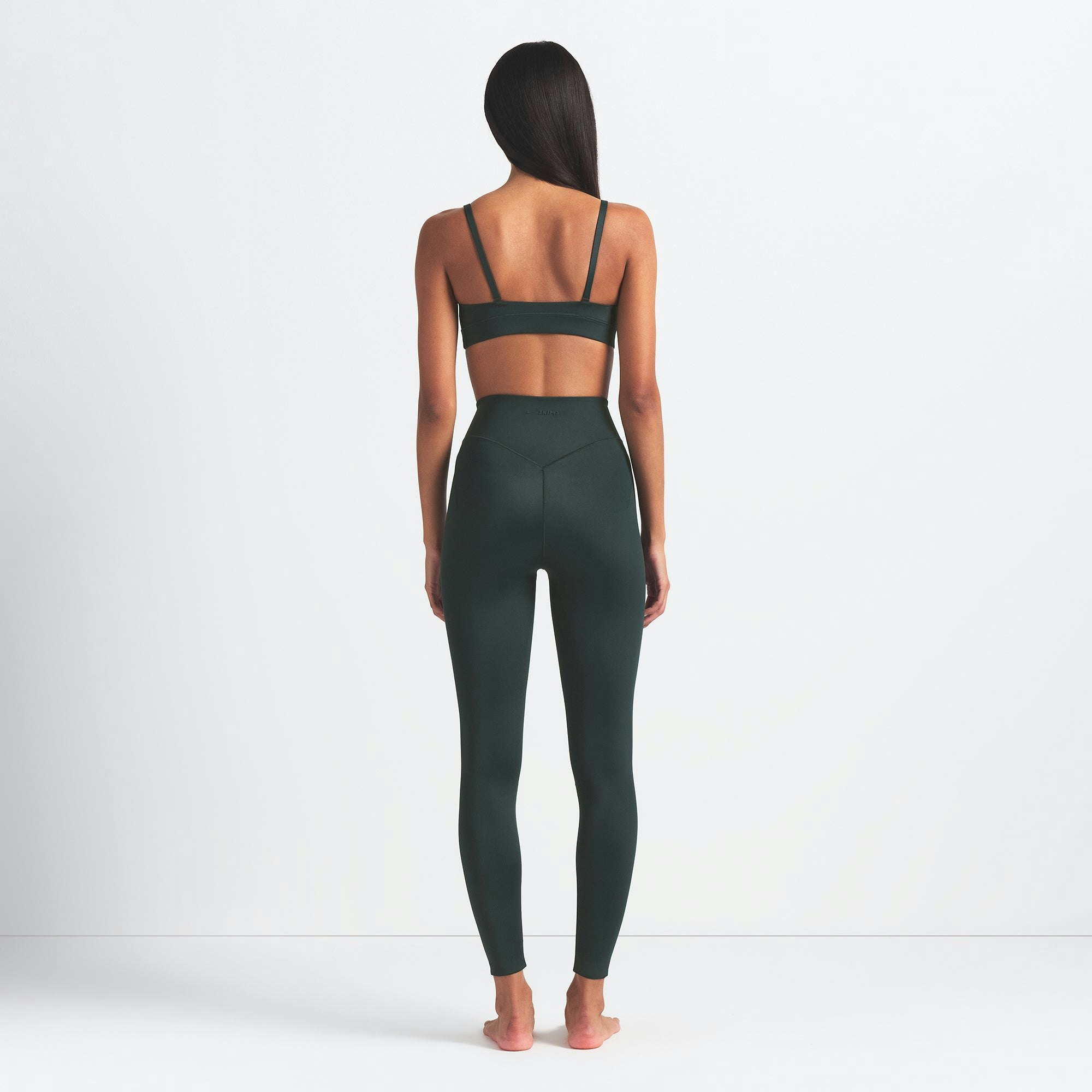 NikeSKIMS SHINE BONDED WAIST 26" LEGGING | DARK TEAL ON A MODEL FRONT VIEW @ | FOCUS: 0.0, 1.0, 0.9
