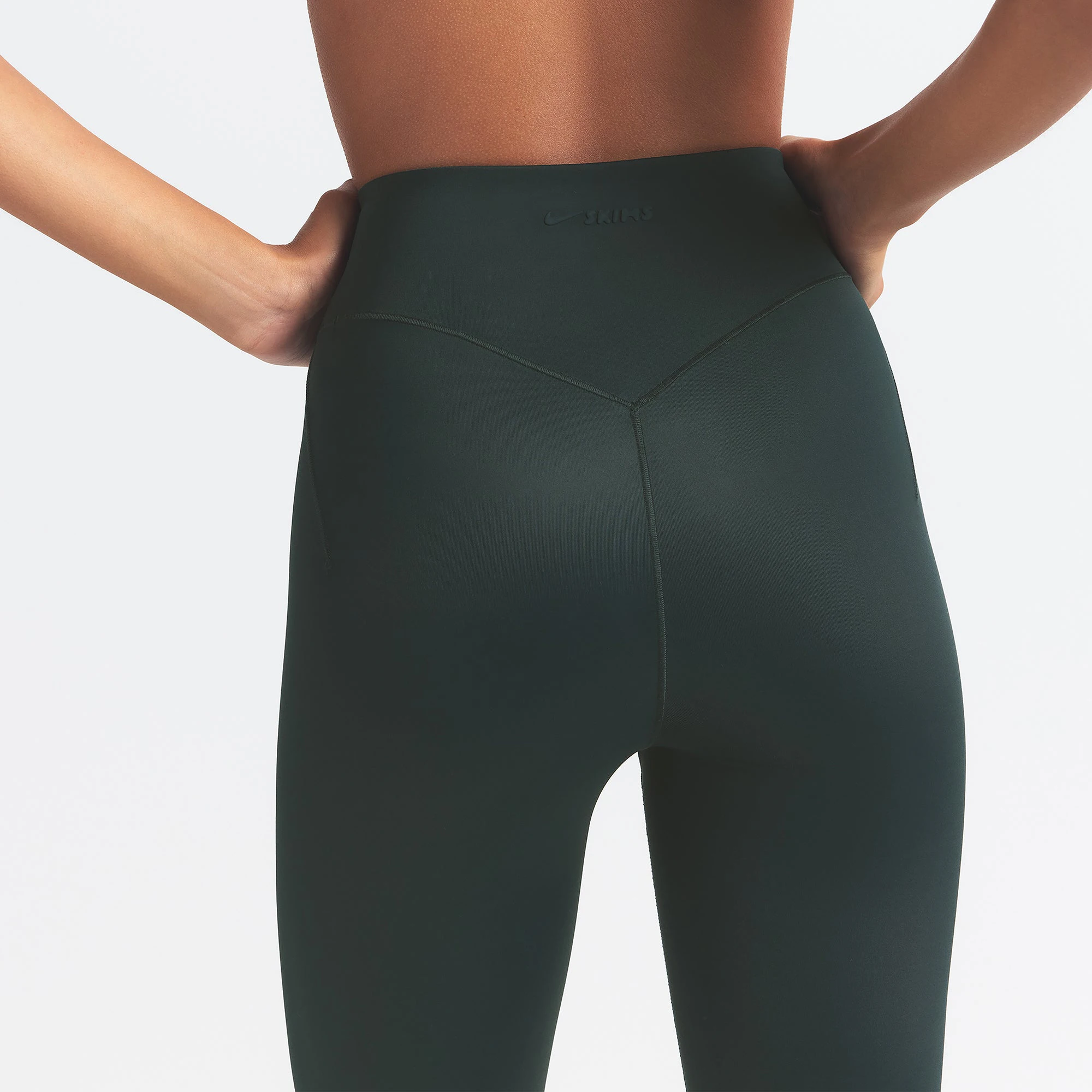 NikeSKIMS SHINE BONDED WAIST 26" LEGGING | DARK TEAL ON A MODEL SIDE VIEW @ | FOCUS: 0.0, 1.0, 0.9