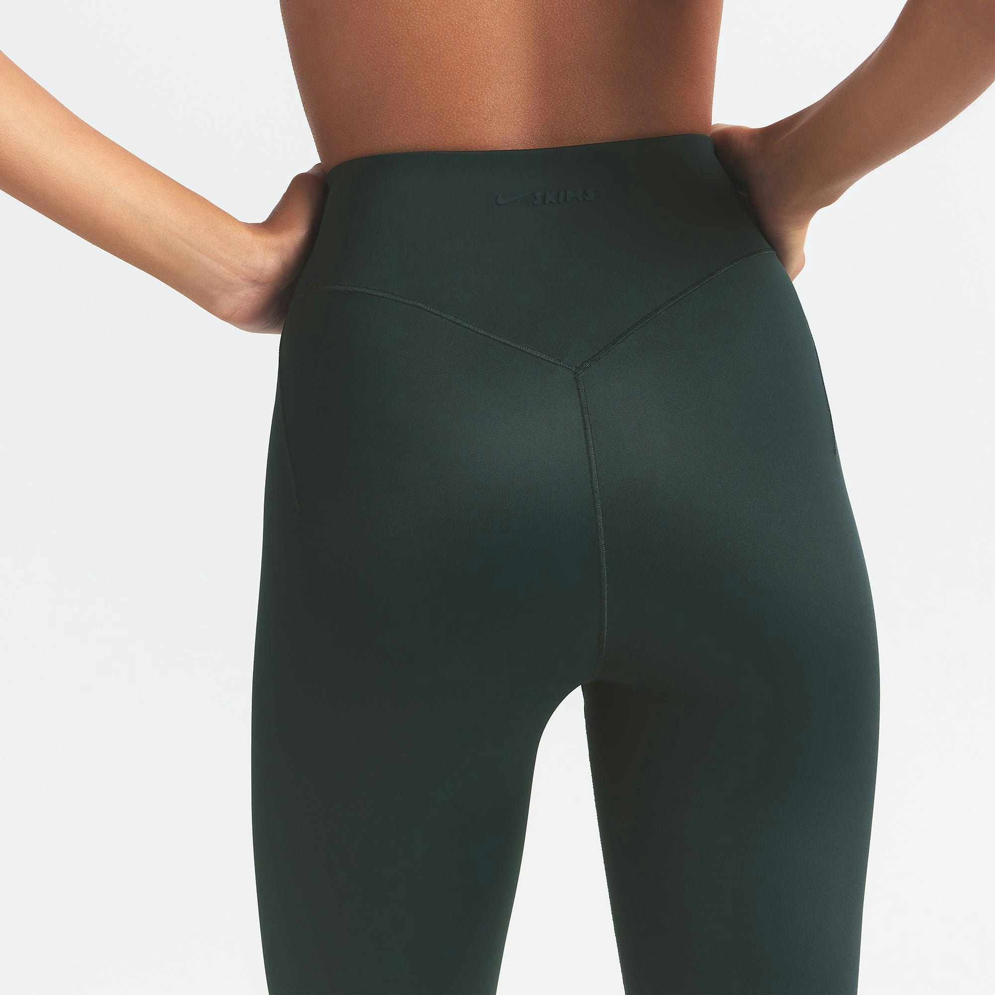 NikeSKIMS SHINE BONDED WAIST 26" LEGGING | DARK TEAL ON A MODEL SIDE VIEW @ | FOCUS: 0.0, 1.0, 0.9