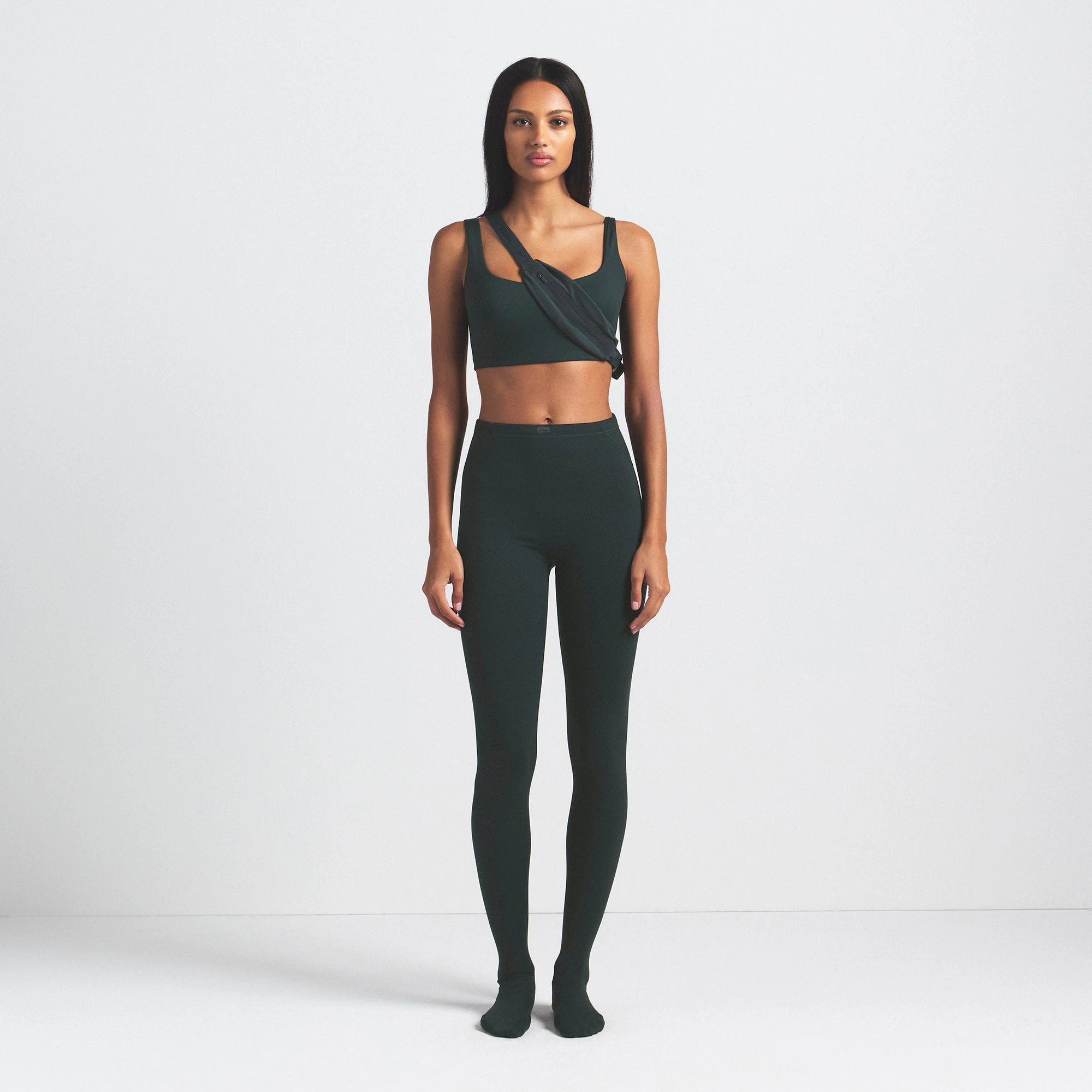 NikeSKIMS MATTE FOOTSIE GRIP LEGGING | DARK TEAL ON A MODEL FRONT VIEW @ | FOCUS: 0.0, 1.0, 0.9