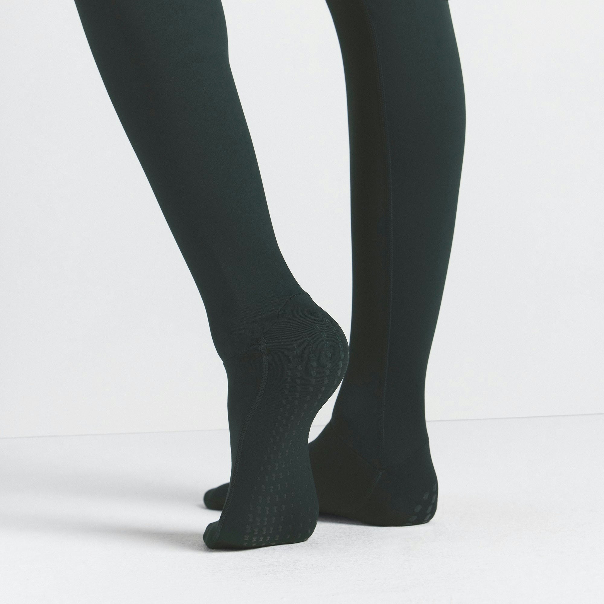 NikeSKIMS MATTE FOOTSIE GRIP LEGGING | DARK TEAL ON A MODEL SIDE VIEW @ | FOCUS: 0.0, 1.0, 0.9