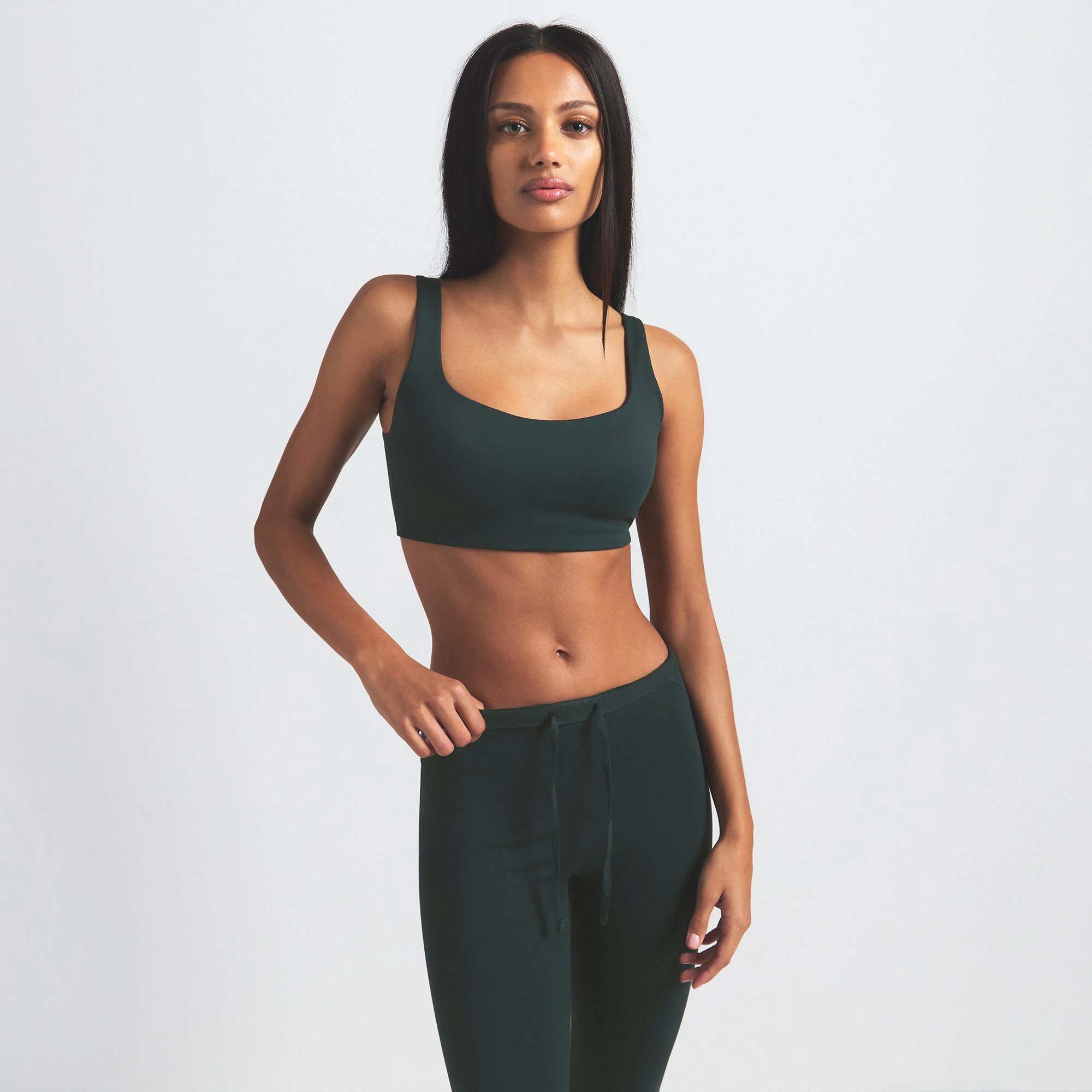 NikeSKIMS MATTE FOOTSIE GRIP LEGGING | DARK TEAL ON A MODEL SIDE VIEW @ | FOCUS: 0.0, 1.0, 0.9