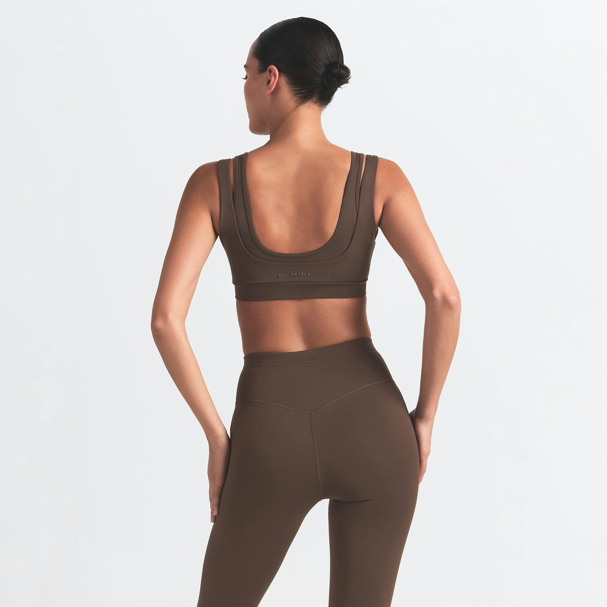 NikeSKIMS MATTE FOOTSIE GRIP LEGGING | DARK SEPIA ON A MODEL BACK VIEW