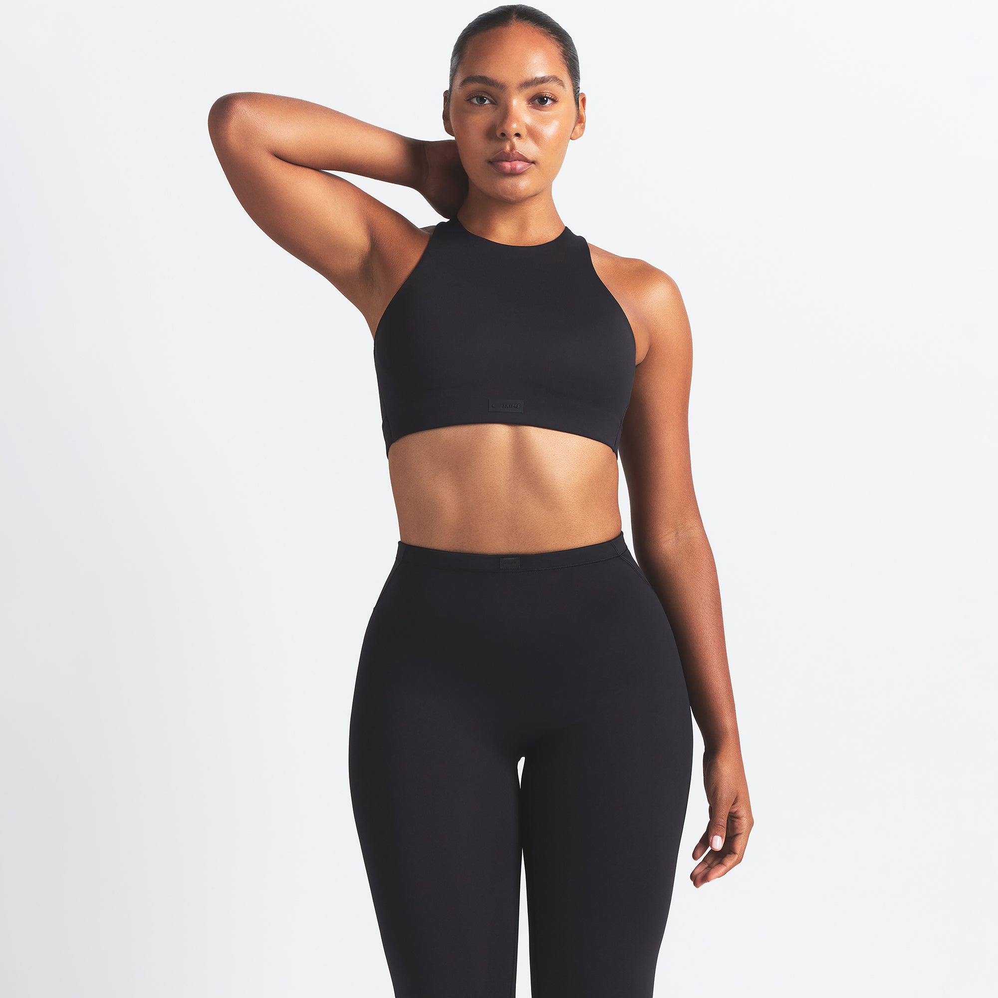 NikeSKIMS MATTE FOOTSIE GRIP LEGGING | OBSIDIAN ON A MODEL FRONT VIEW