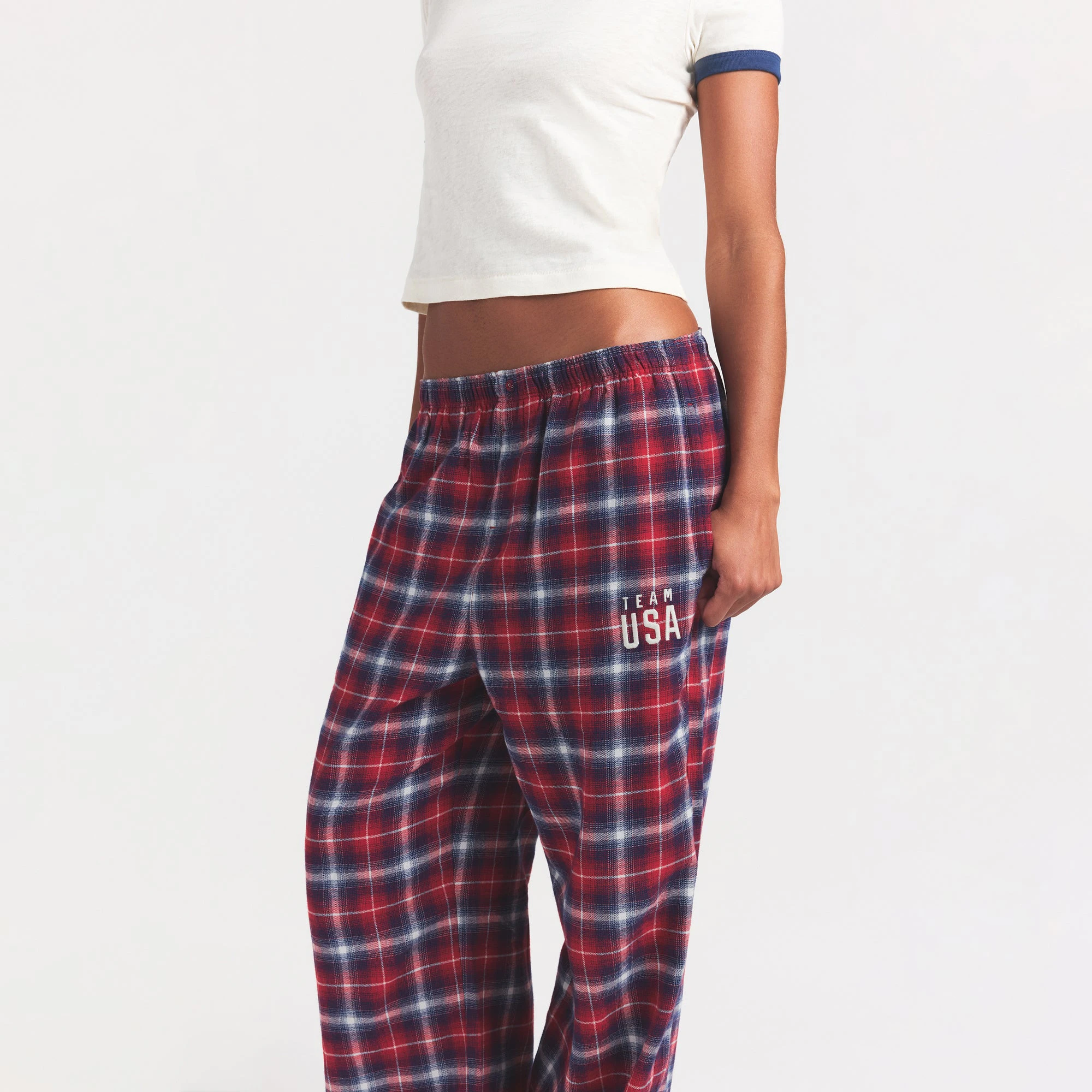 SKIMS FOR TEAM USA FLANNEL SLEEP OLYMPIC PANT | RED PLAID ON A MODEL SIDE VIEW @ | FOCUS: 0.0, 1.0, 0.9