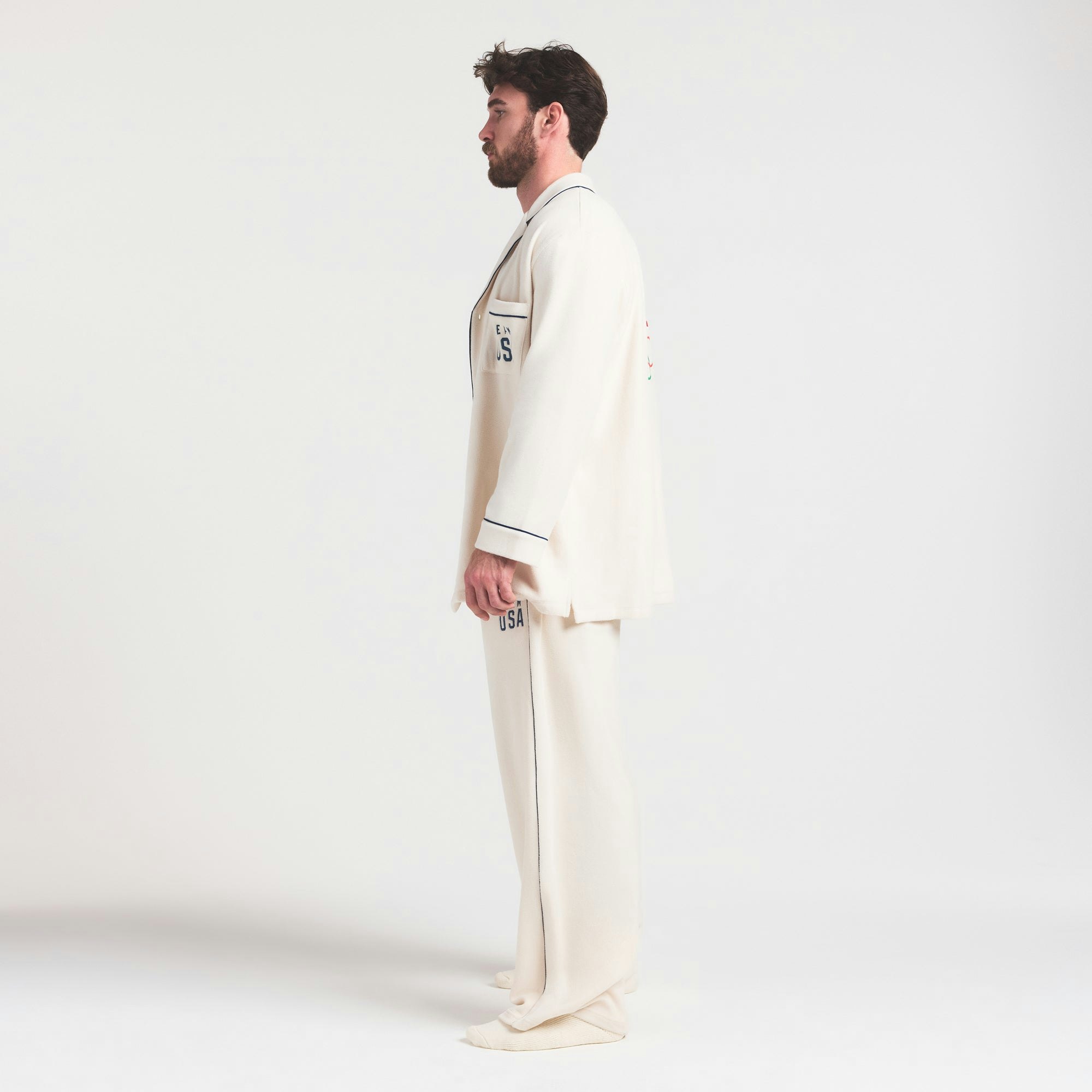 SKIMS FOR TEAM USA UNISEX FLEECE OLYMPIC SLEEP PANT | ECRU ON A MODEL FRONT VIEW @ | FOCUS: 0.0, 1.0, 0.9