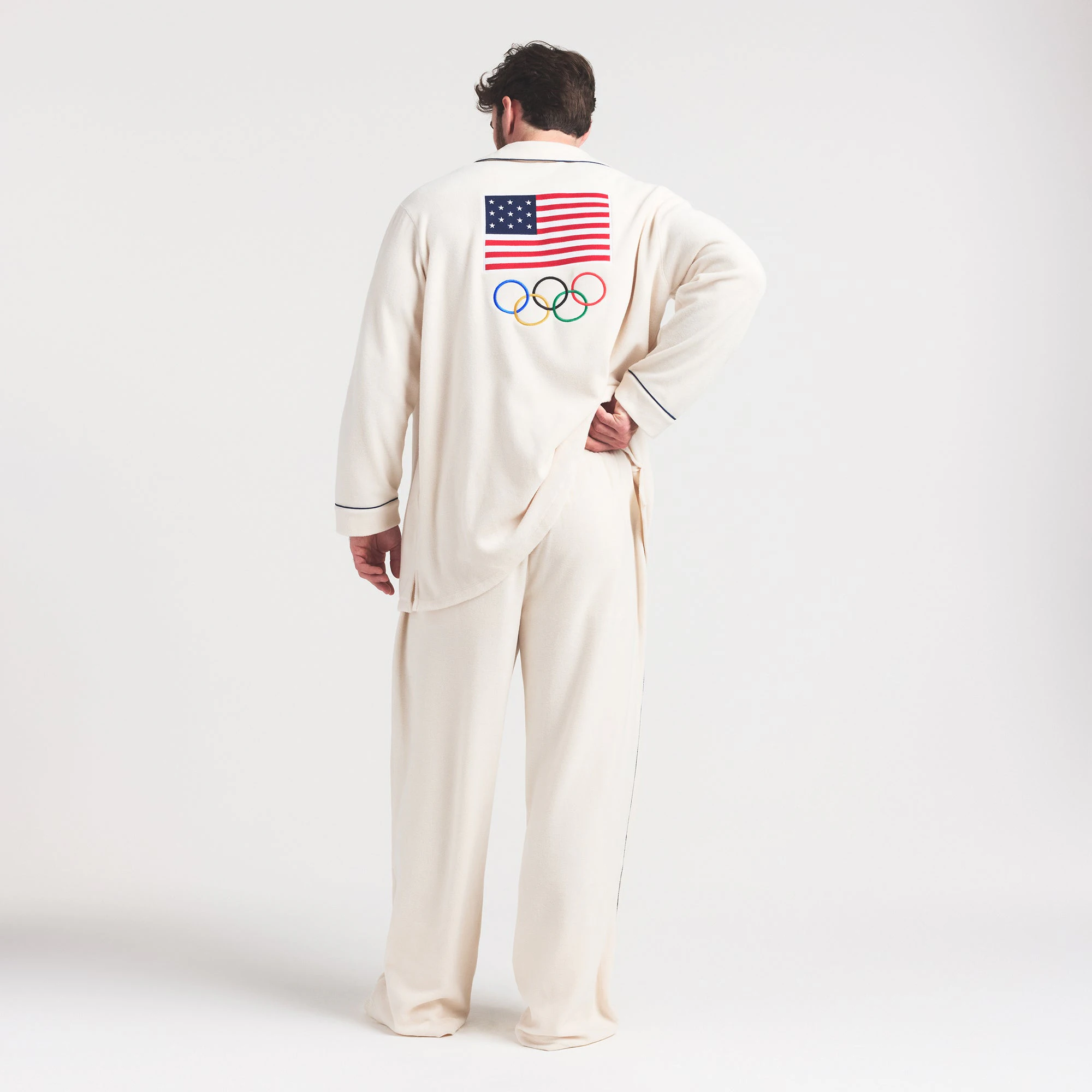 SKIMS FOR TEAM USA UNISEX FLEECE OLYMPIC SLEEP PANT | ECRU ON A MODEL FRONT VIEW @ | FOCUS: 0.0, 1.0, 0.9