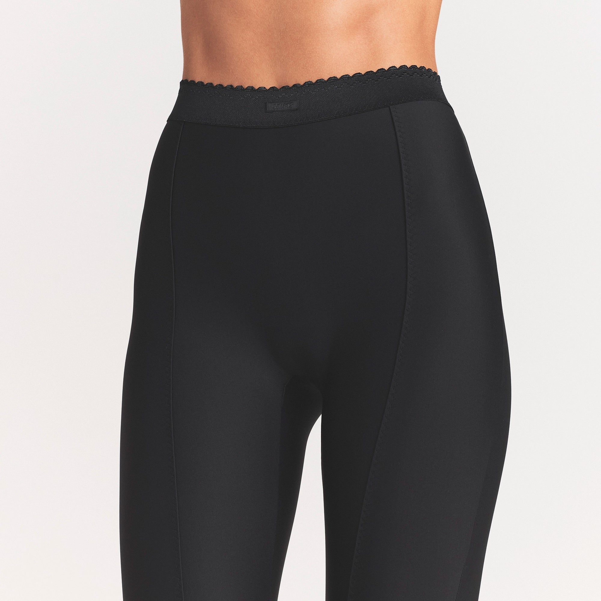 SKIMS BODY HIGH-WAISTED FLARE PANT | ONYX ON A MODEL SIDE VIEW