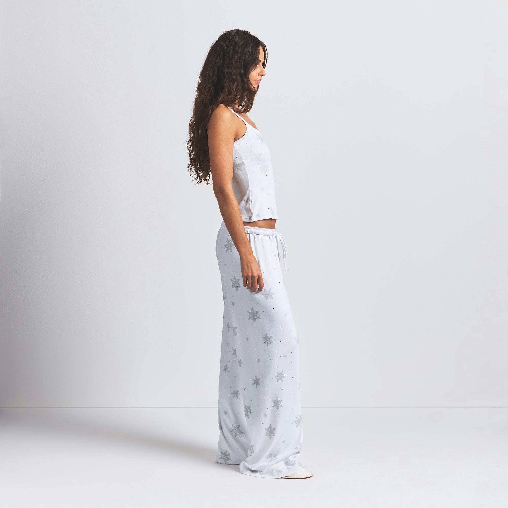 LOGO PLUSH POINTELLE RHINESTONE STRAIGHT LEG PANT | SNOW RHINESTONE PRINT ON A MODEL SIDE VIEW @ | FOCUS: 0.0, 1.0, 0.9