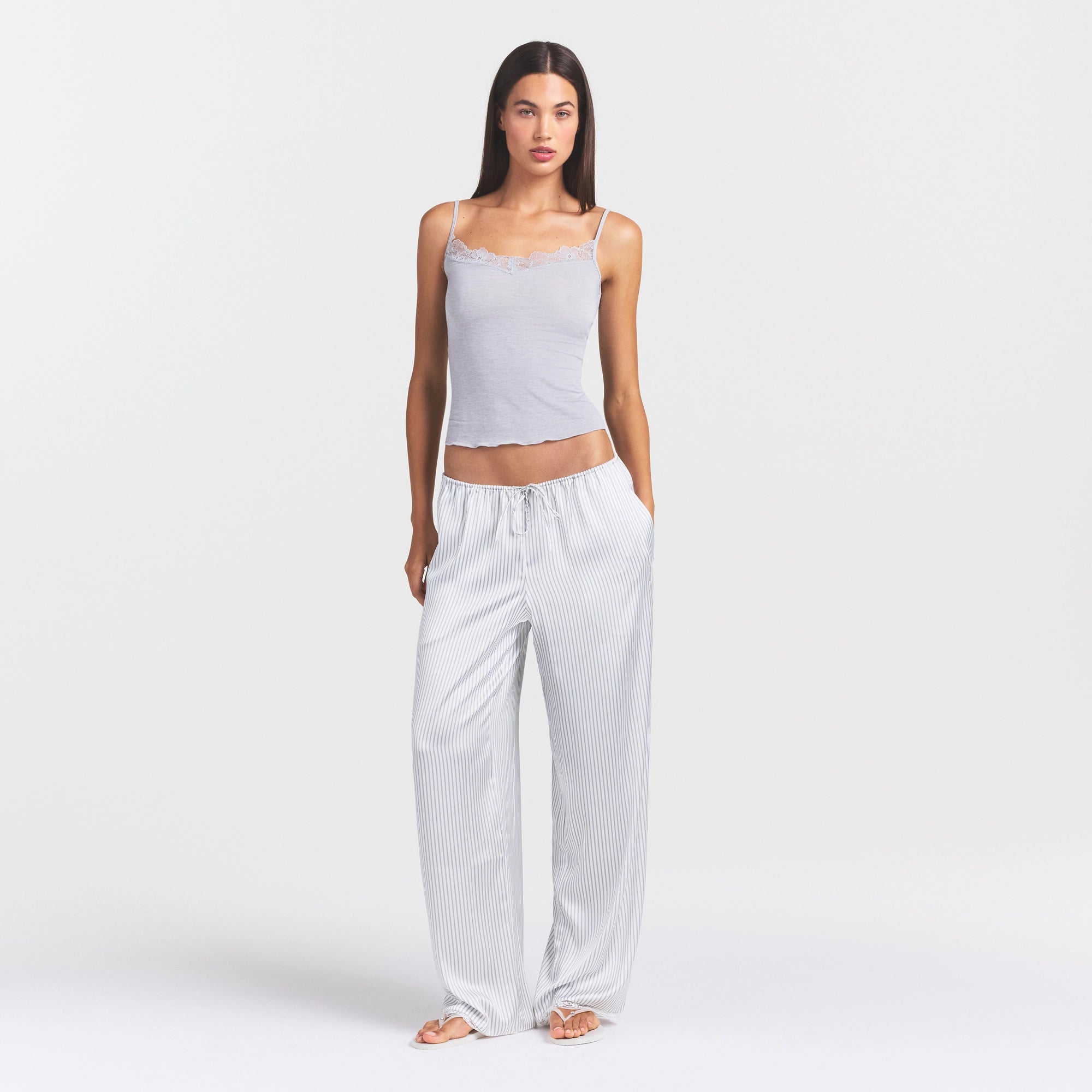 WOVEN SHINE LACE PANT | SILVER TRIPLE PINSTRIPE ON A MODEL SIDE VIEW @ | FOCUS: 0.0, 1.0, 0.9