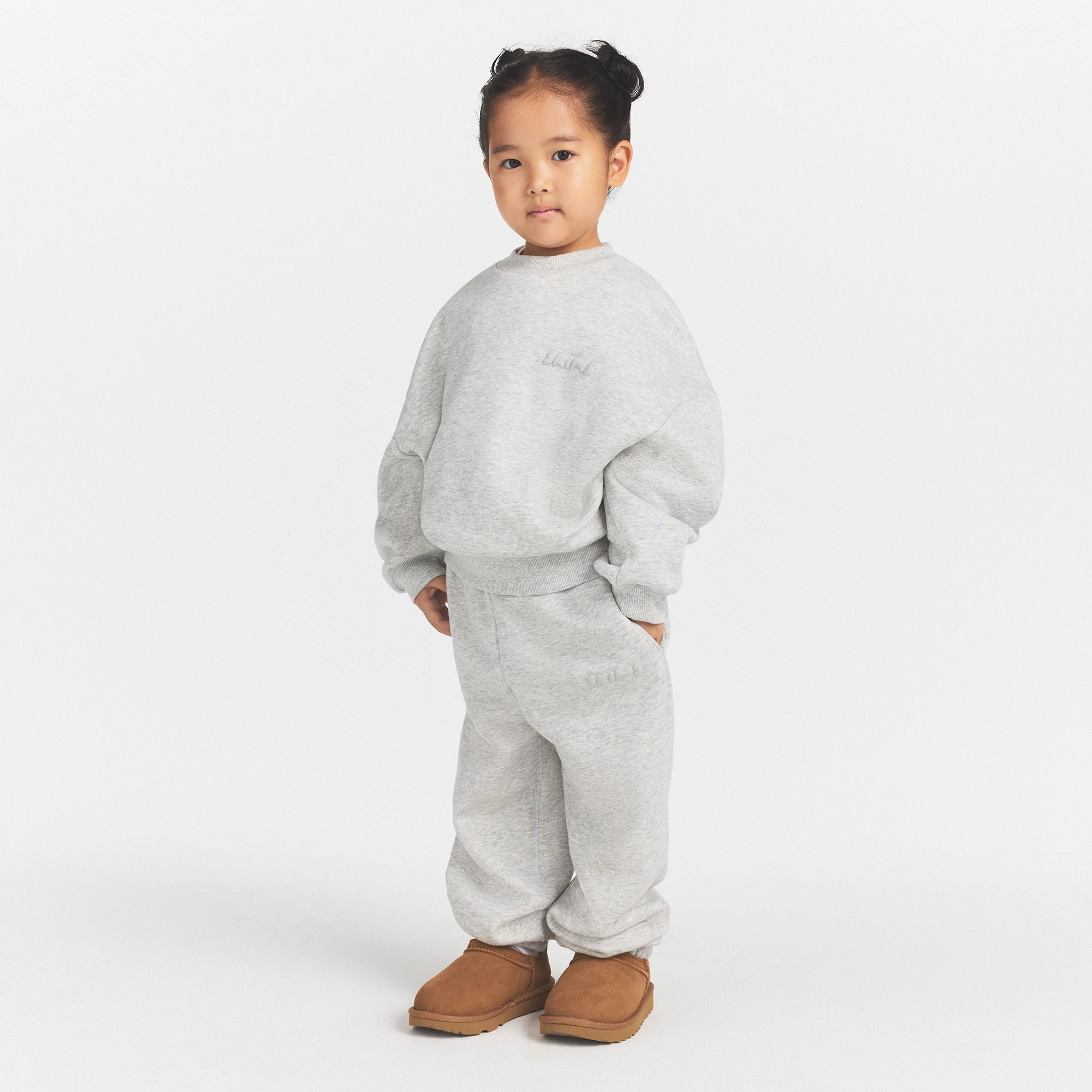 KIDS FLEECE JOGGER | LIGHT HEATHER GREY ON A MODEL SIDE VIEW @ | FOCUS: 0.0, 1.0, 0.9