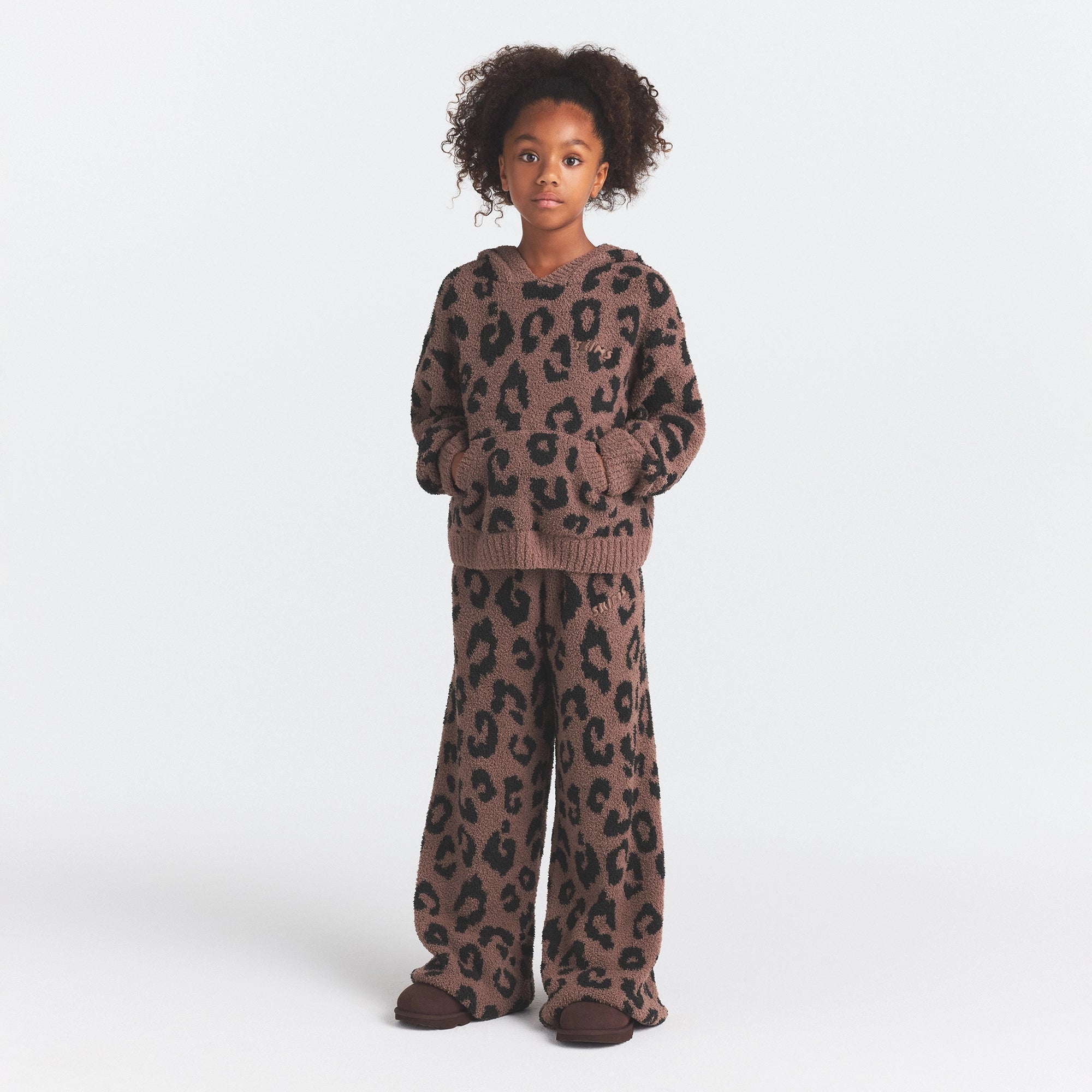 KIDS COZY STRAIGHT LEG PANT | UMBER LEOPARD PRINT ON A MODEL FRONT VIEW @ | FOCUS: 0.0, 1.0, 0.9