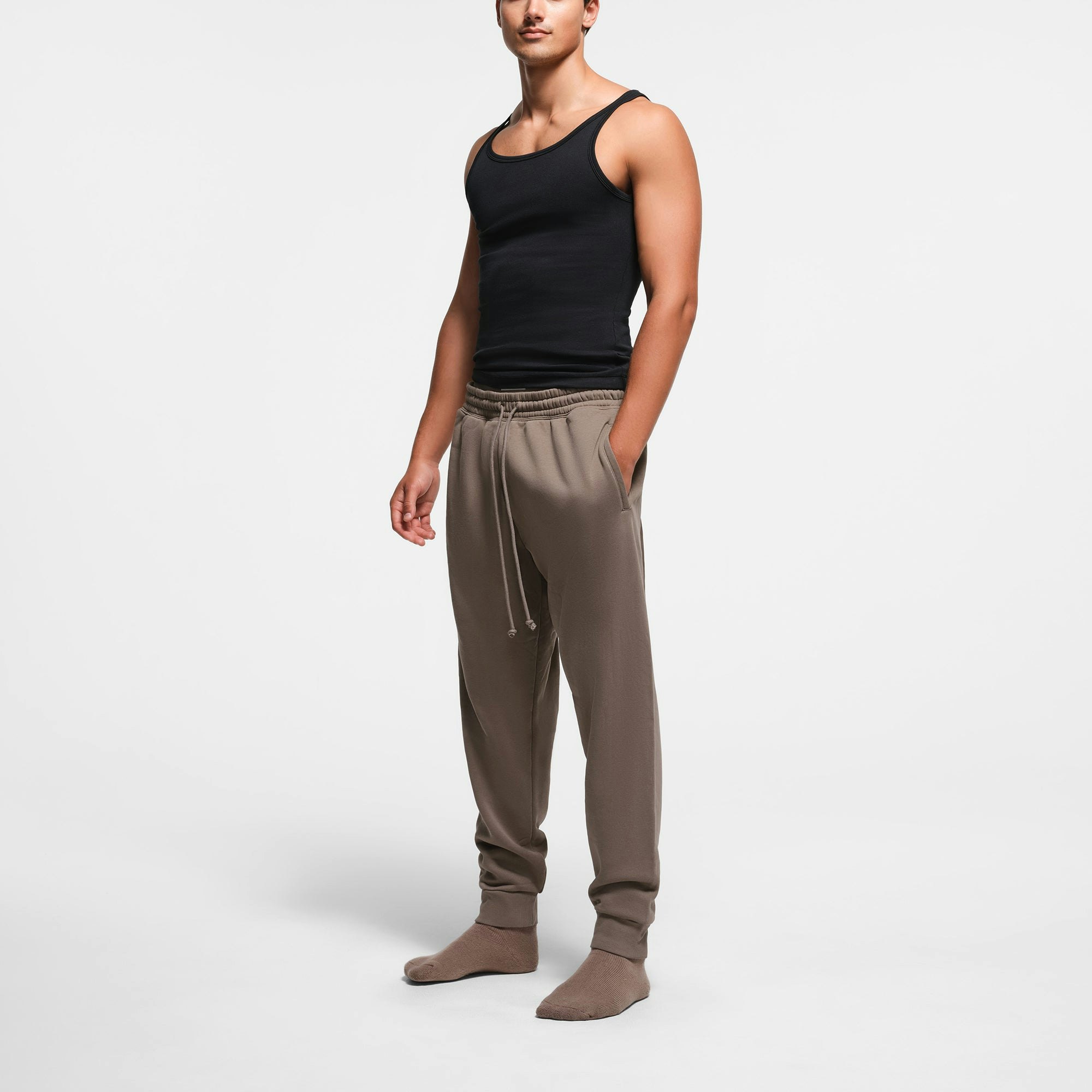 FLEECE LOUNGE MENS TAPERED JOGGER | TRUFFLE ON A MODEL SIDE VIEW