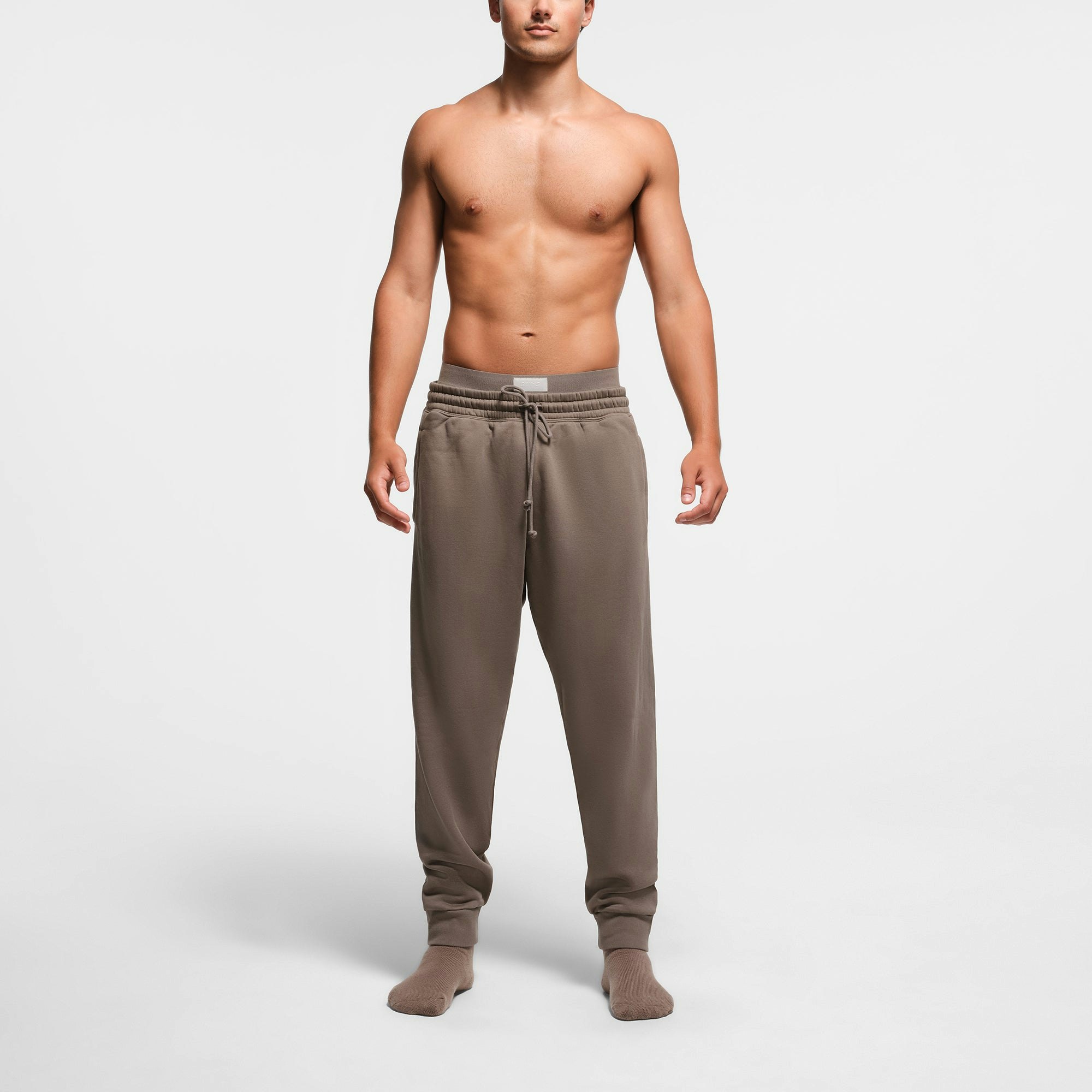 FLEECE LOUNGE MENS TAPERED JOGGER | TRUFFLE ON A MODEL FRONT VIEW