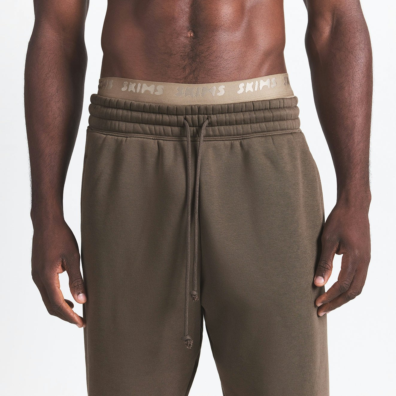 FLEECE LOUNGE MENS TAPERED JOGGER | DRIFTWOOD ON A MODEL FRONT VIEW @ | FOCUS: 0.9, 0.1, 0.7