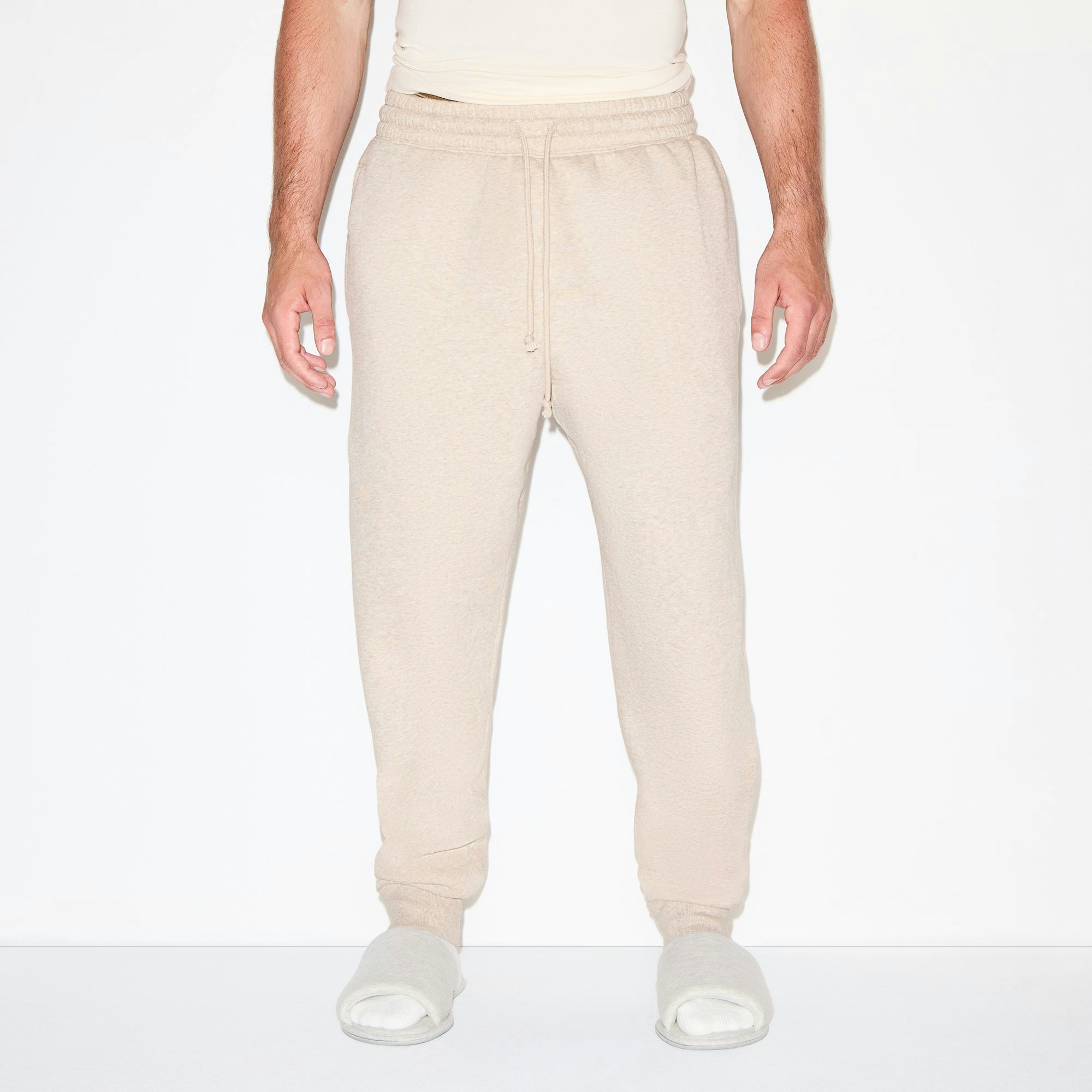 FLEECE LOUNGE MENS TAPERED JOGGER | DESERT HEATHER ON A MODEL SIDE VIEW @ | FOCUS: 0.0, 1.0, 0.9