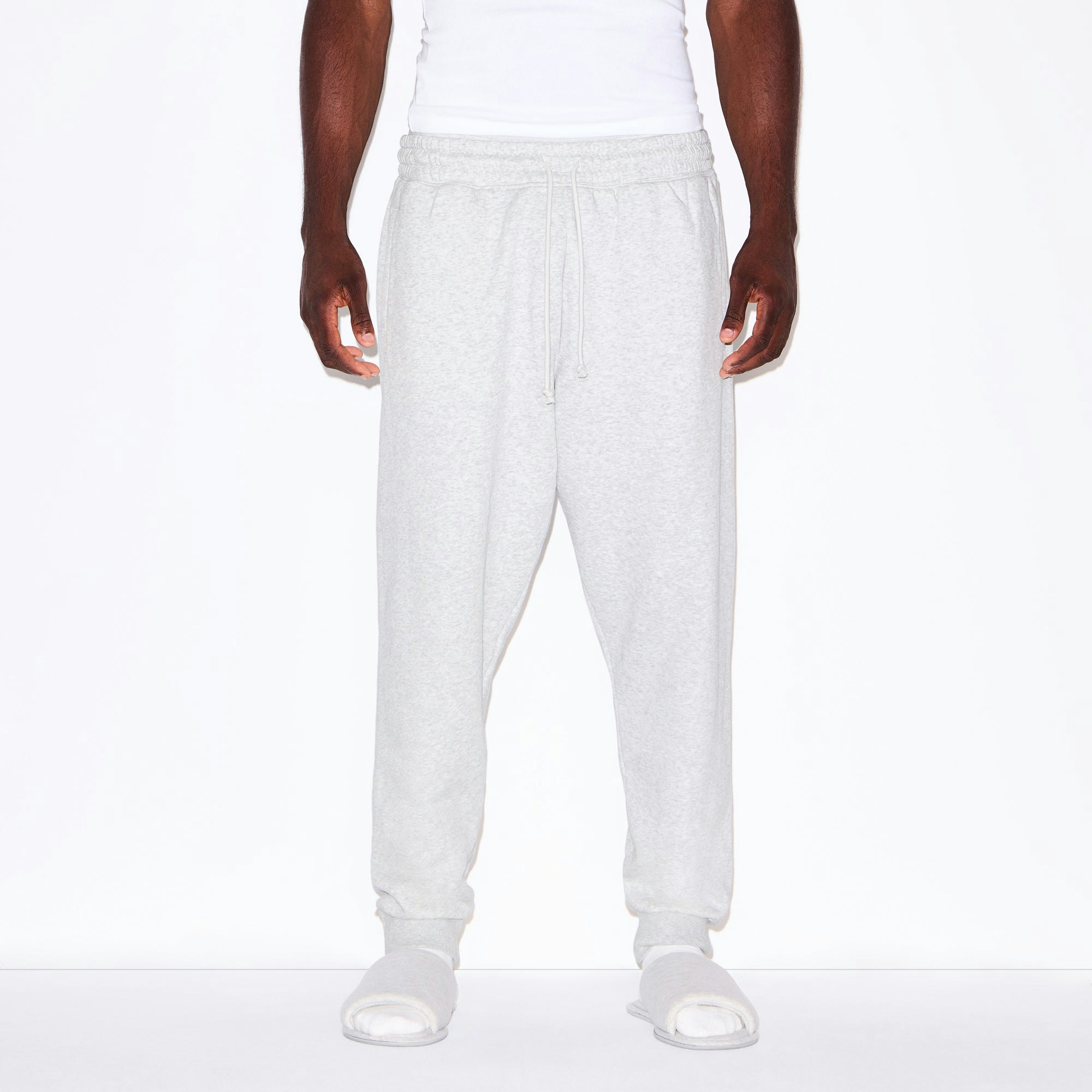 FLEECE LOUNGE MENS TAPERED JOGGER | LIGHT HEATHER GREY ON A MODEL SIDE VIEW @ | FOCUS: 0.0, 1.0, 0.9