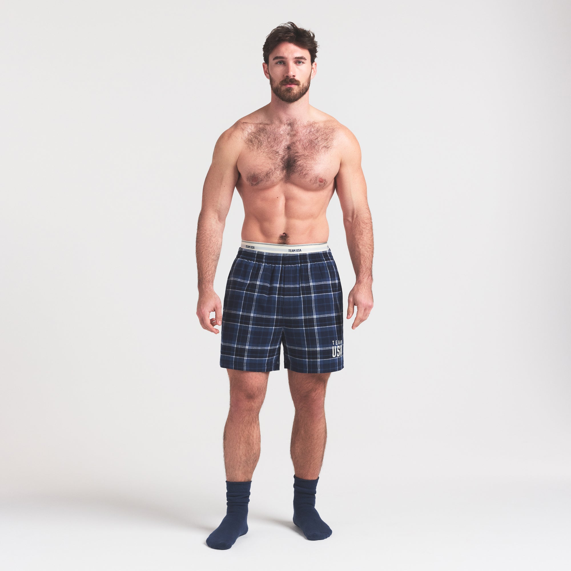 SKIMS FOR TEAM USA FLANNEL SLEEP MENS OLYMPIC SHORT | NAVY PLAID ON A MODEL FRONT VIEW @ | FOCUS: 0.0, 1.0, 0.9