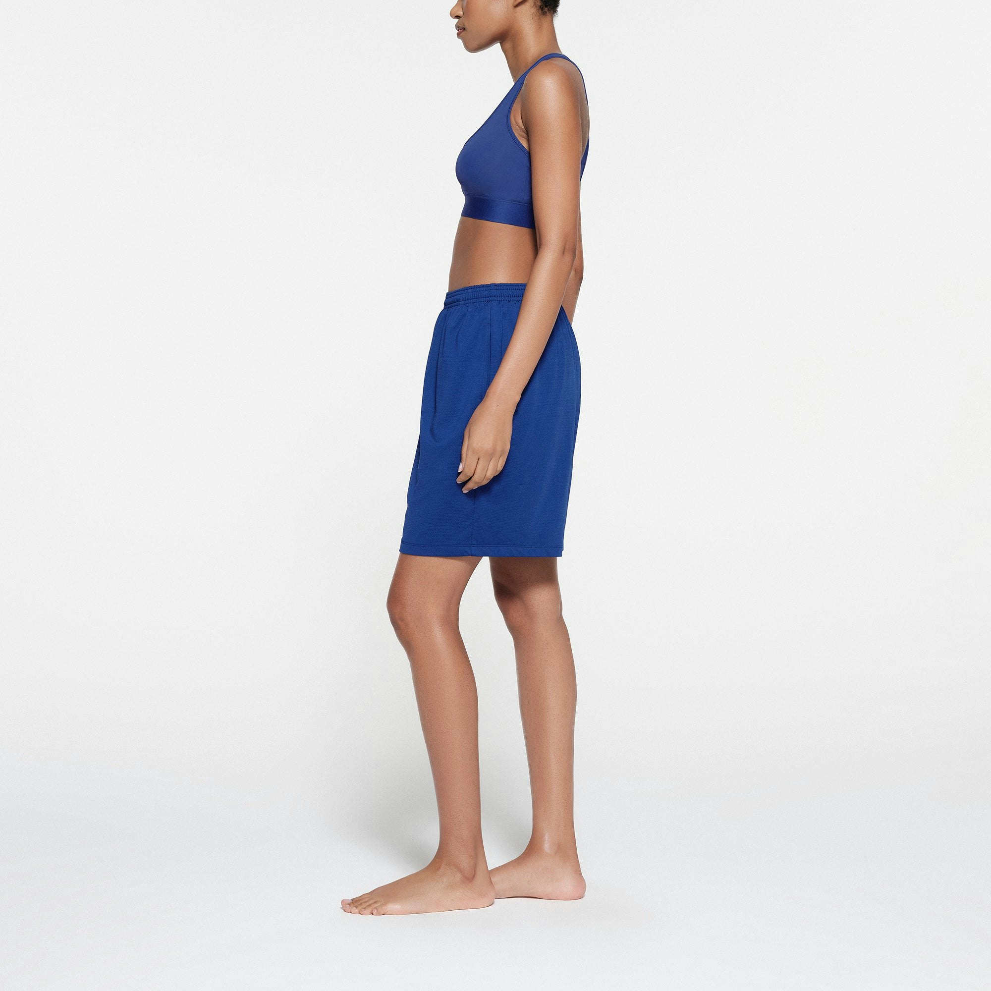 SKIMS TRACK MESH SHORT | COBALT ON A MODEL SIDE VIEW