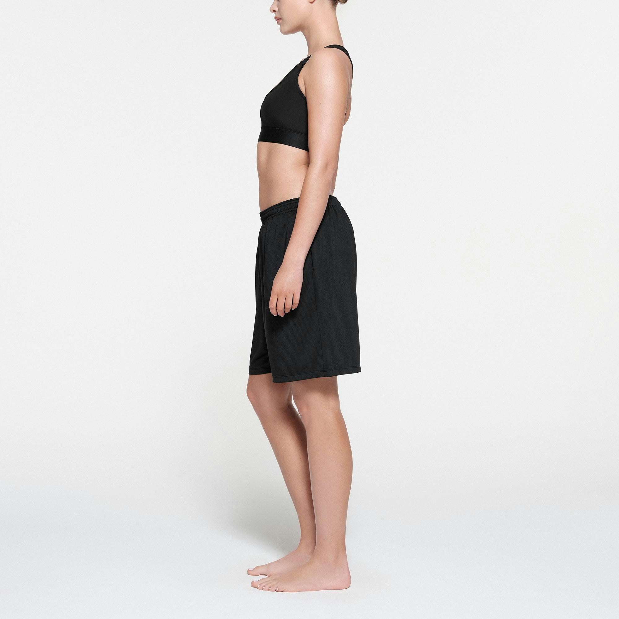 SKIMS TRACK MESH SHORT | ONYX ON A MODEL SIDE VIEW