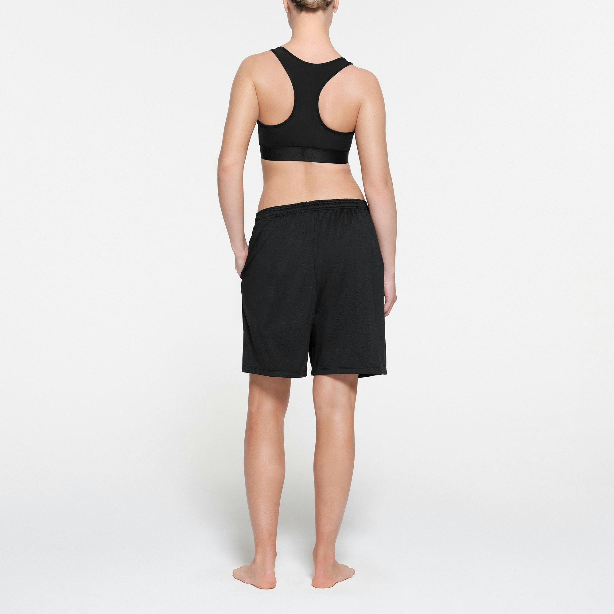 SKIMS TRACK MESH SHORT | ONYX ON A MODEL BACK VIEW