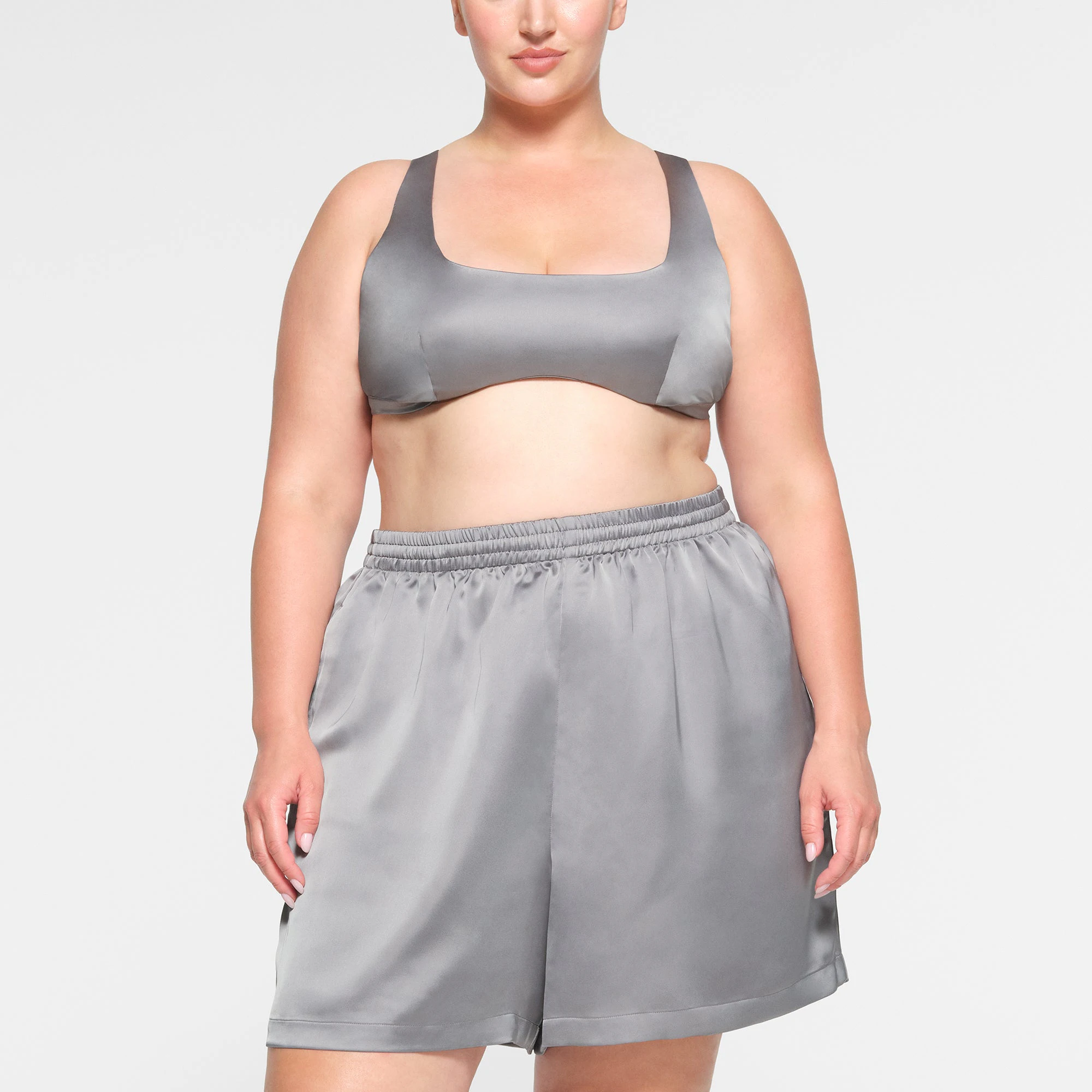 SKIMS SPORTY SATIN LOOSE SHORT WORN BY A MODEL IN FRONT VIEW