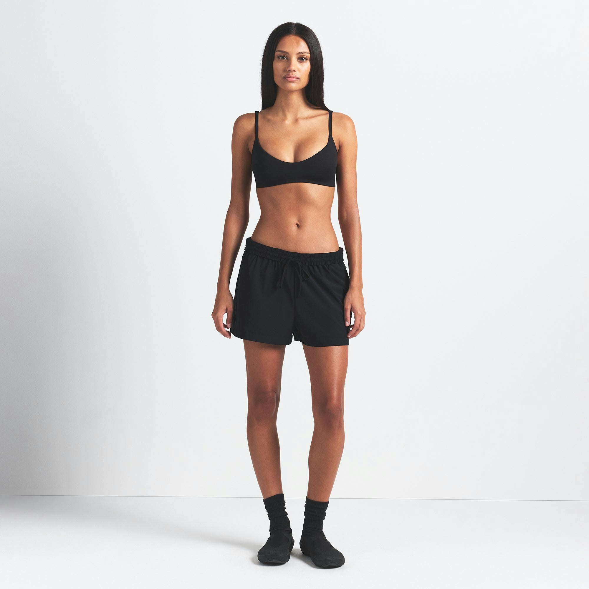 NikeSKIMS WOVEN NYLON 5" TRACK SHORT | OBSIDIAN ON A MODEL FRONT VIEW @ | FOCUS: 0.0, 1.0, 0.9