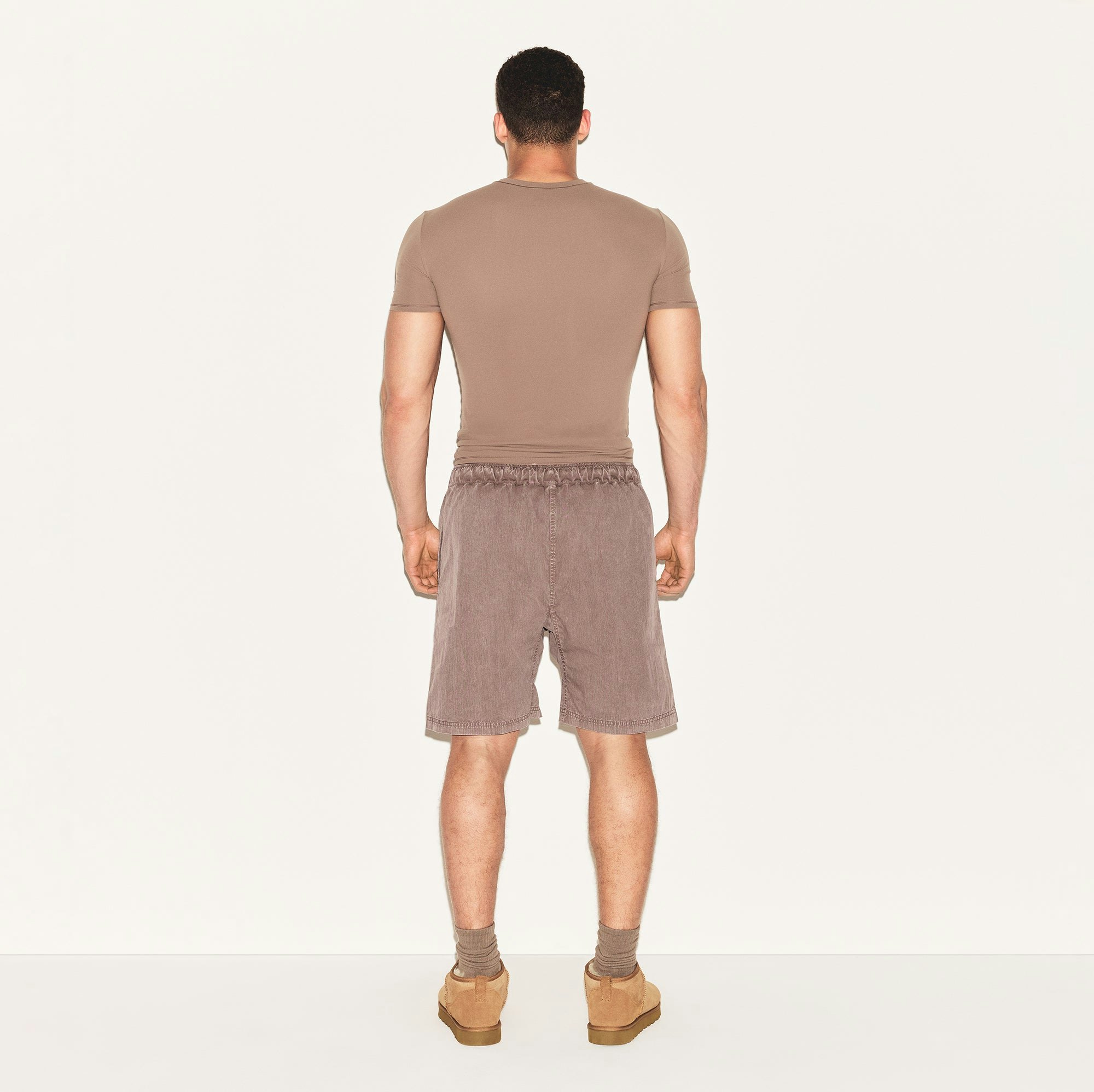WOVEN MENS SHORT | UMBER ON A MODEL BACK VIEW | FOCUS: 0.0, 1.0, 0.9