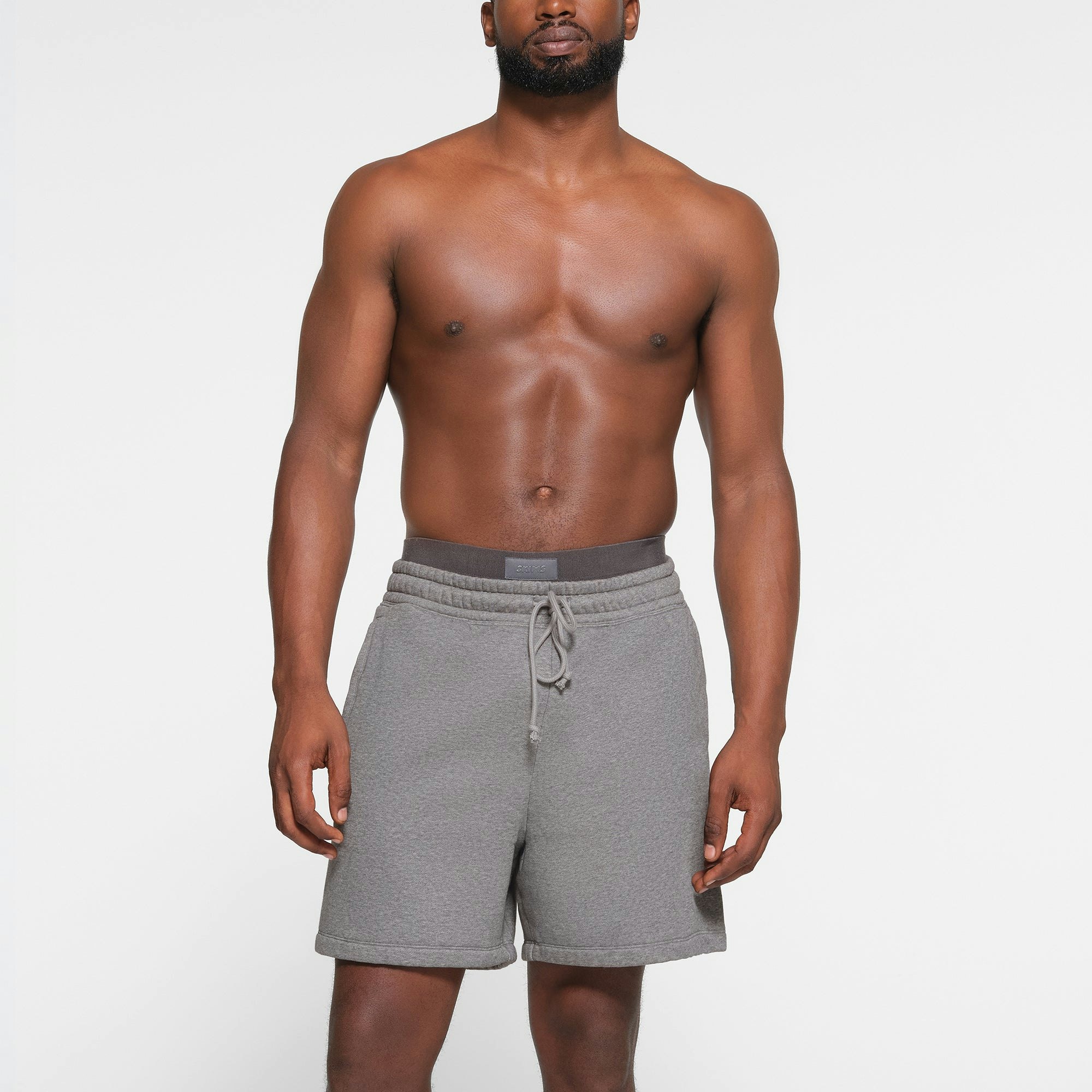 LOUNGE FLEECE MENS SHORT | DARK HEATHER GREY ON A MODEL FRONT VIEW