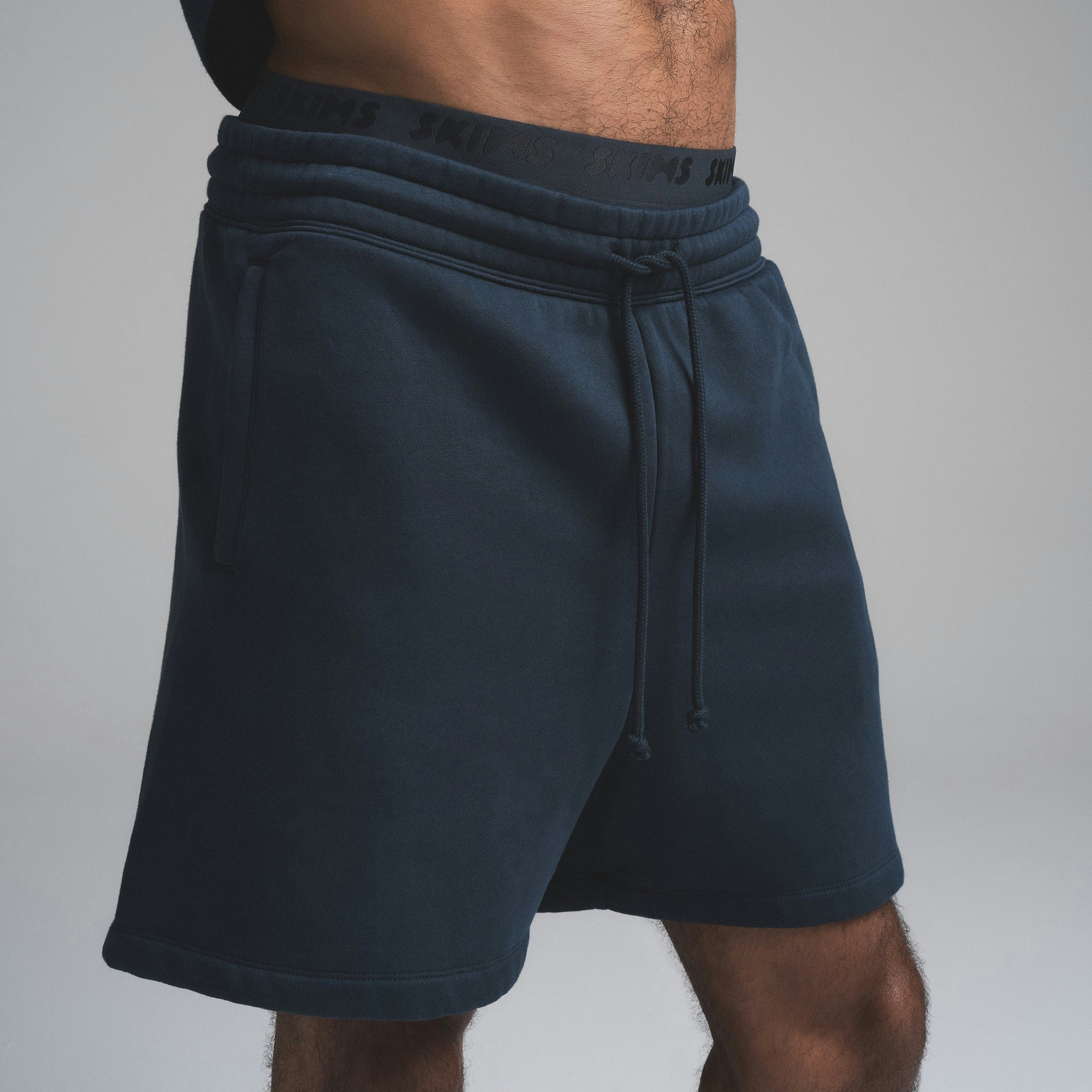 FLEECE LOUNGE MENS RELAXED SHORT | NAVY ON A MODEL SIDE VIEW | FOCUS: 0.0, 1.0, 0.9