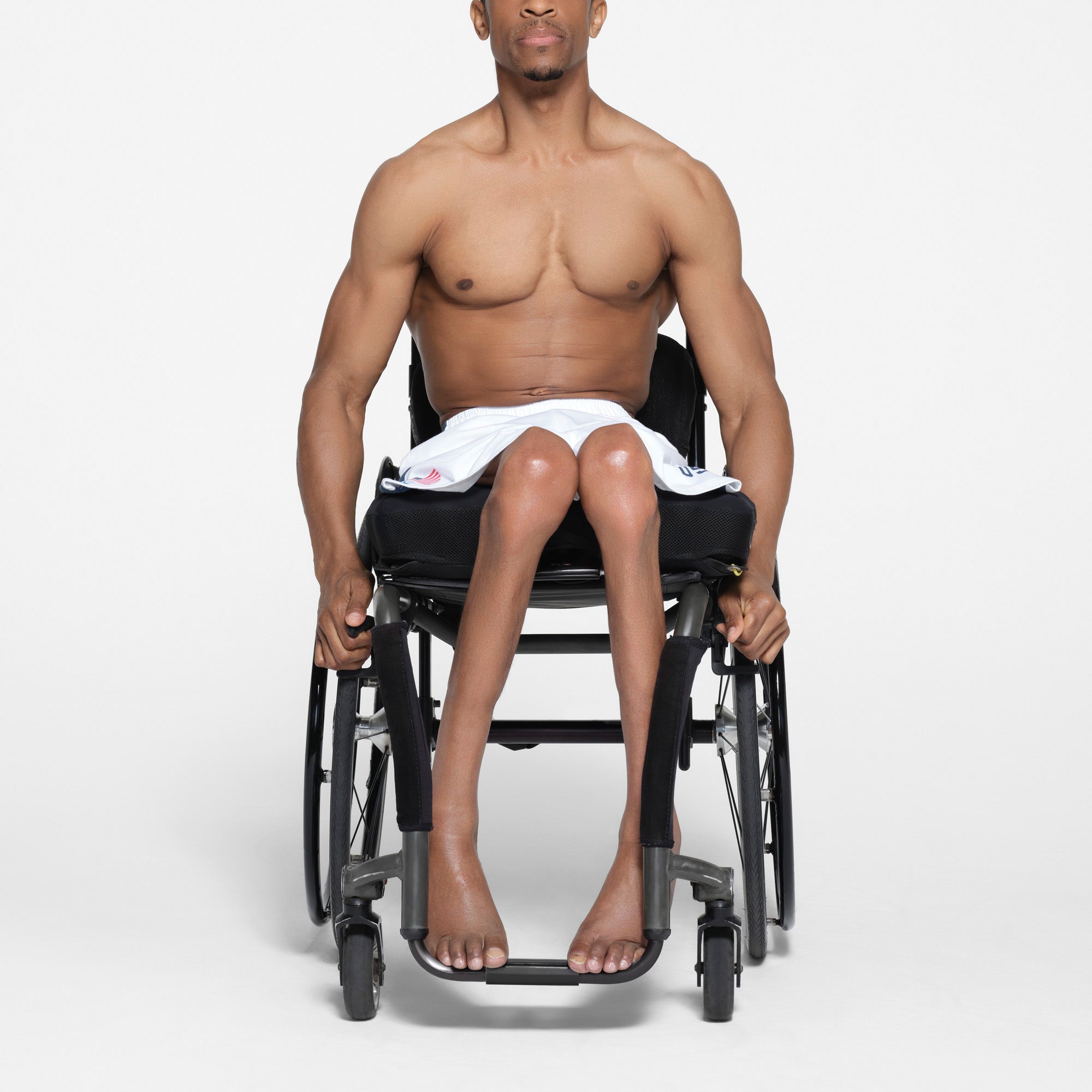 SKIMS FOR TEAM USA SKIMS COTTON MENS PARALYMPIC SHORT | WHITE ON A MODEL FRONT VIEW | FOCUS: 0.1, 1, 0.9