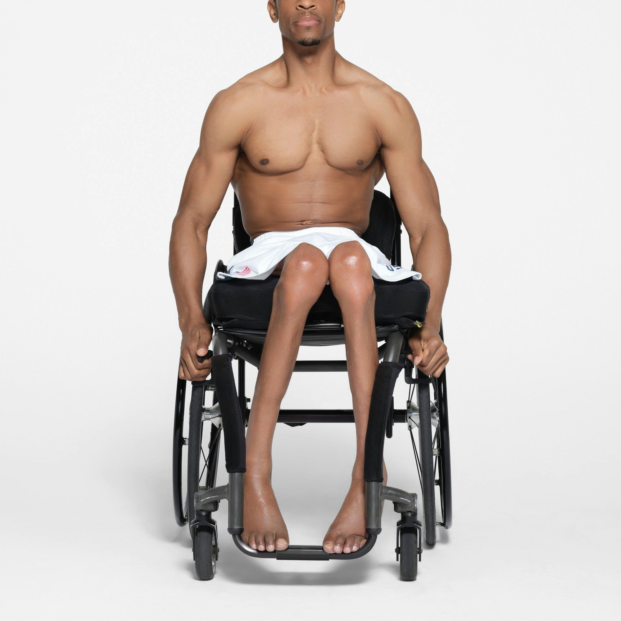 SKIMS FOR TEAM USA SKIMS COTTON MENS PARALYMPIC SHORT | WHITE ON A MODEL FRONT VIEW | FOCUS: 0.1, 1, 0.9