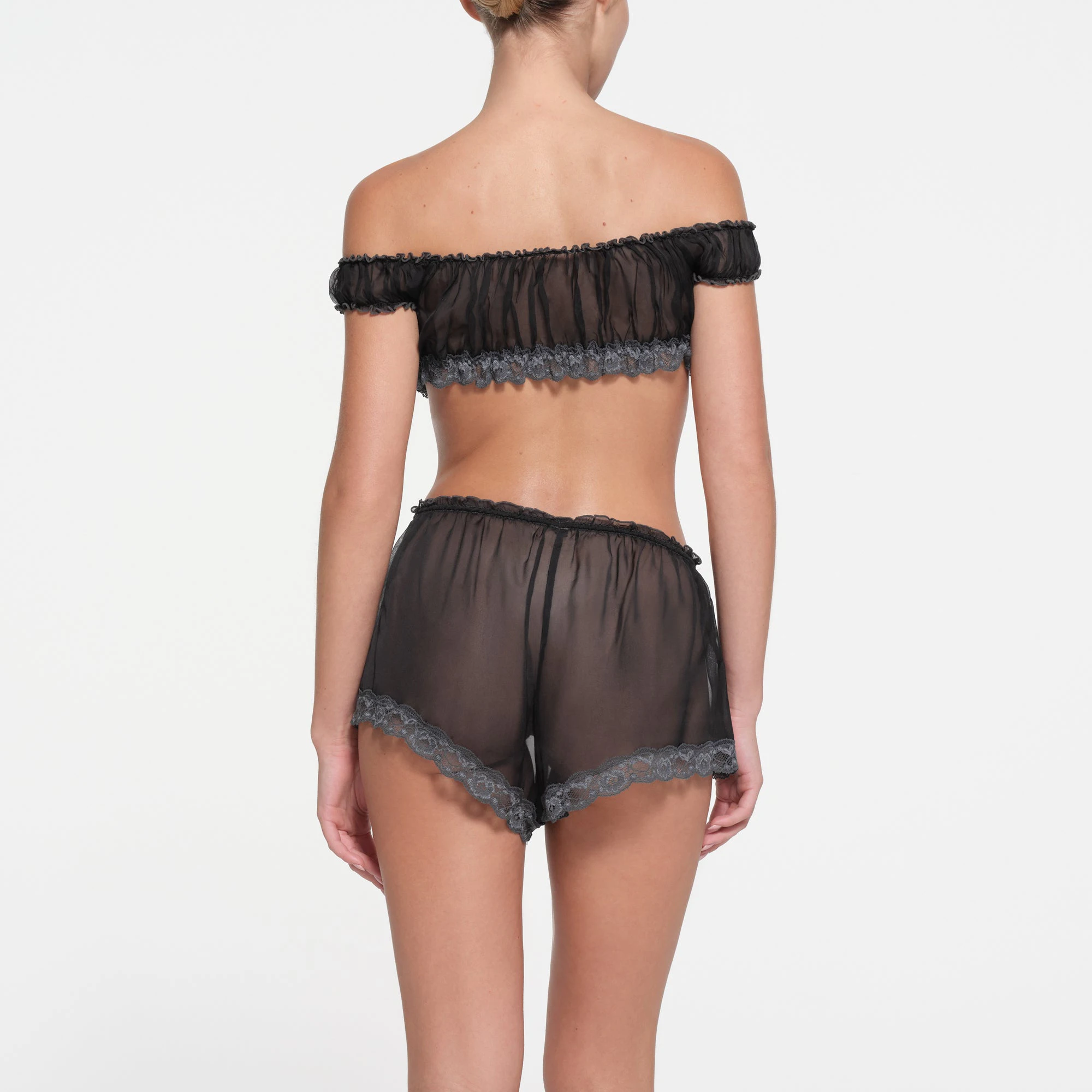 SKIMS ROMANCE SHORT | ONYX ON A MODEL BACK VIEW